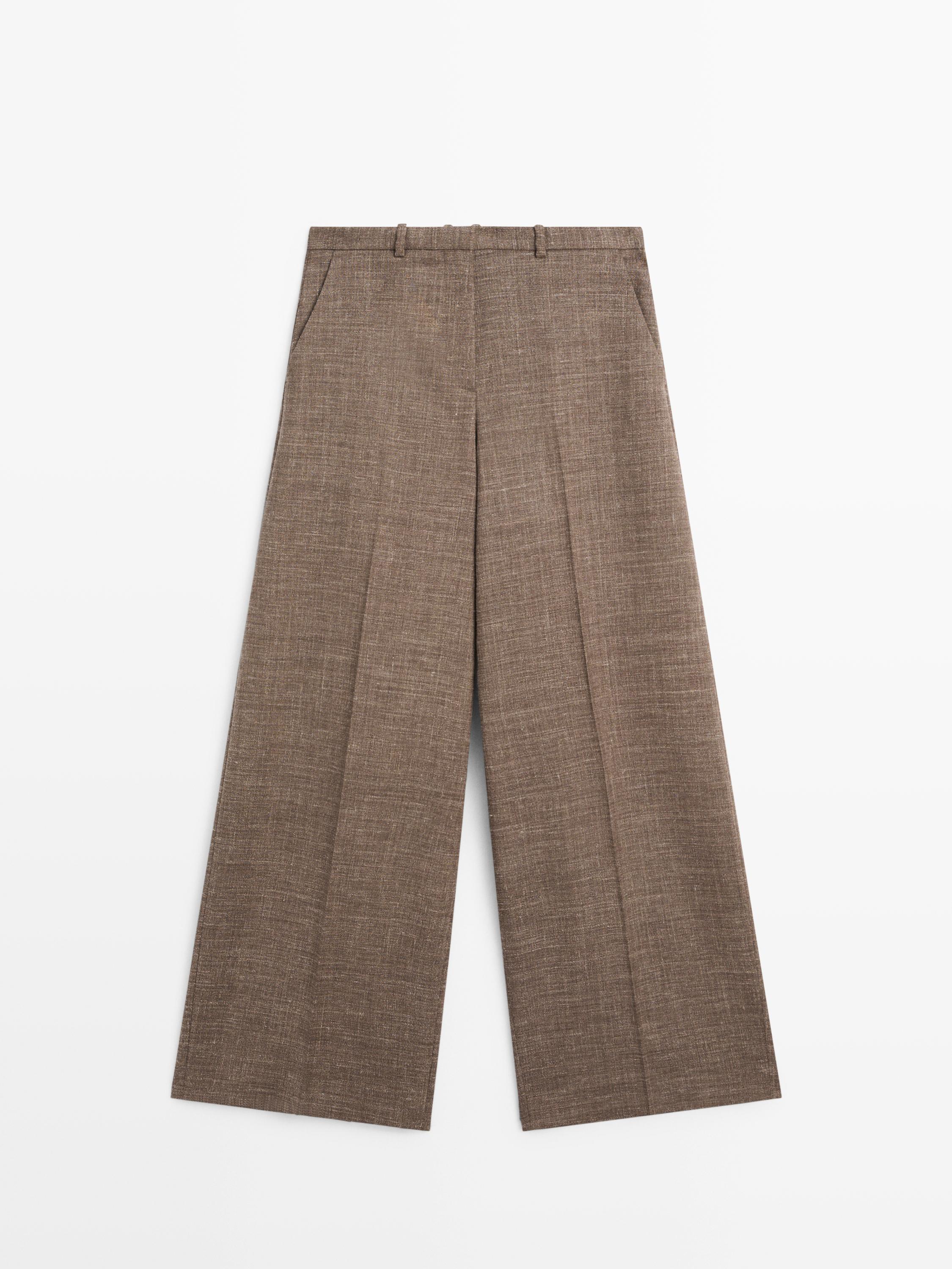 Front view of taupe wide-leg pants with side pockets and belt loops.