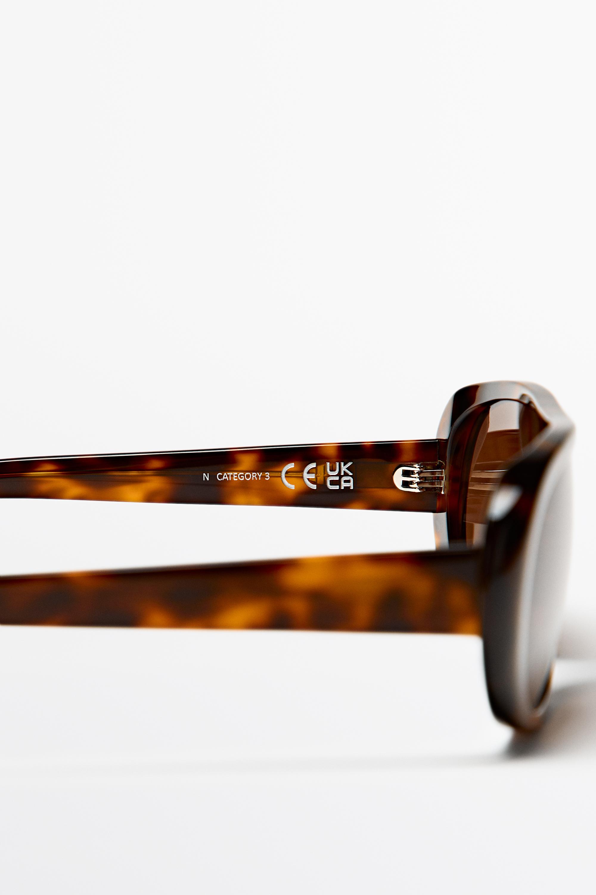 Oval tortoiseshell-effect sunglasses — BROWN