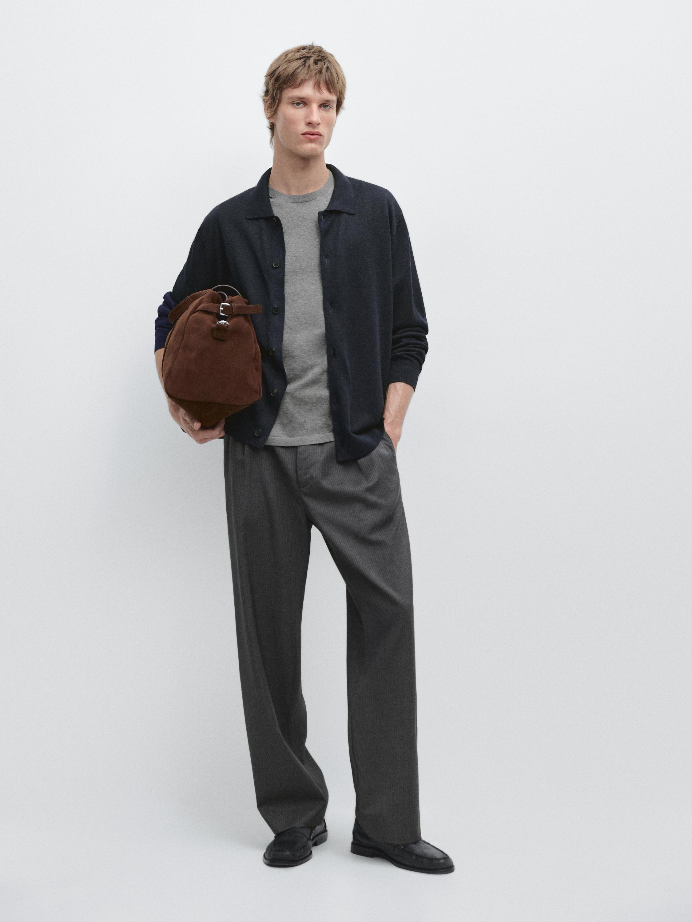 Navy blue cardigan set with buttons, gray t-shirt, wide gray pants, and black shoes.