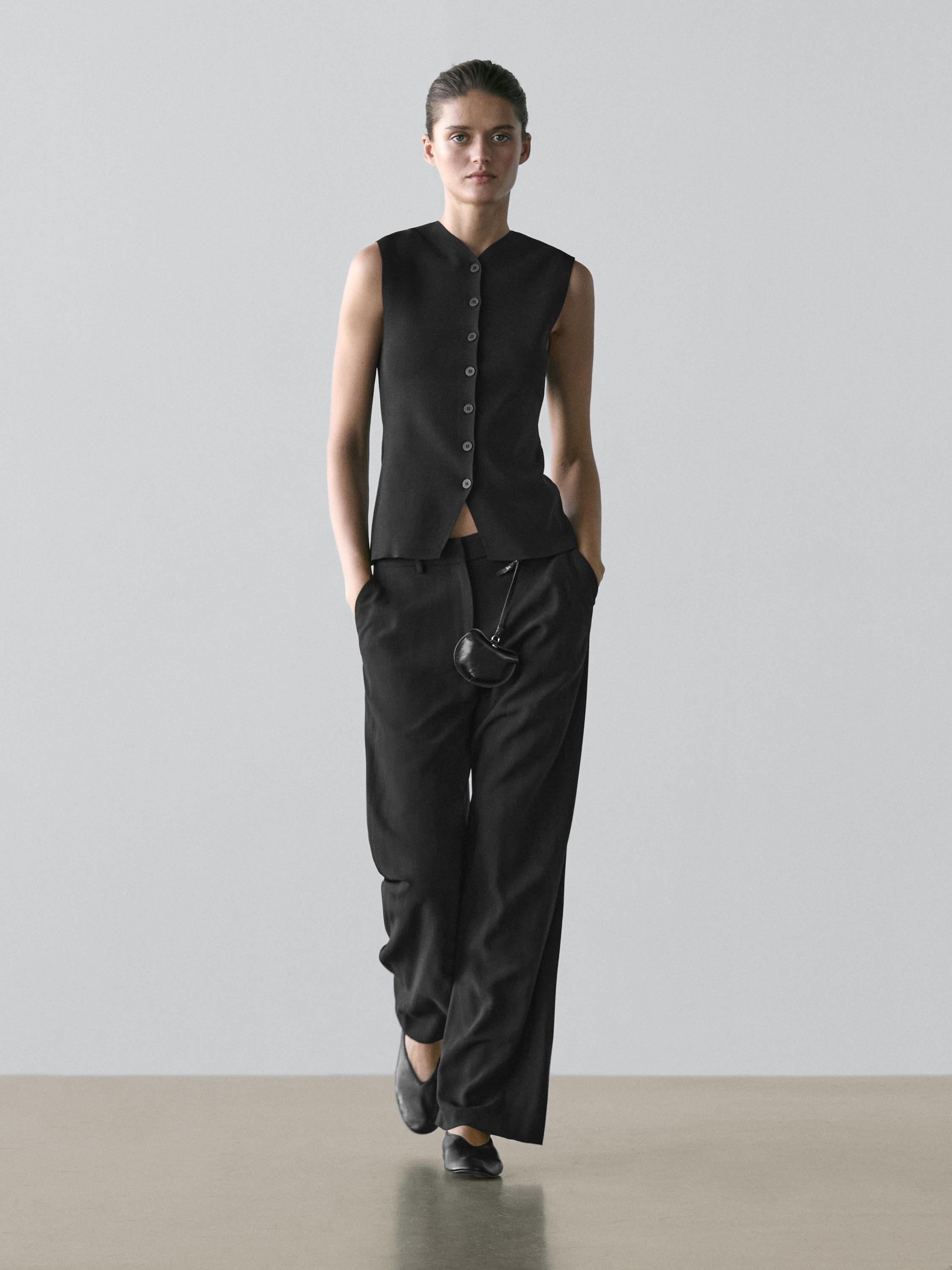 Black sleeveless button-down vest and wide-leg black pants with side pockets set.