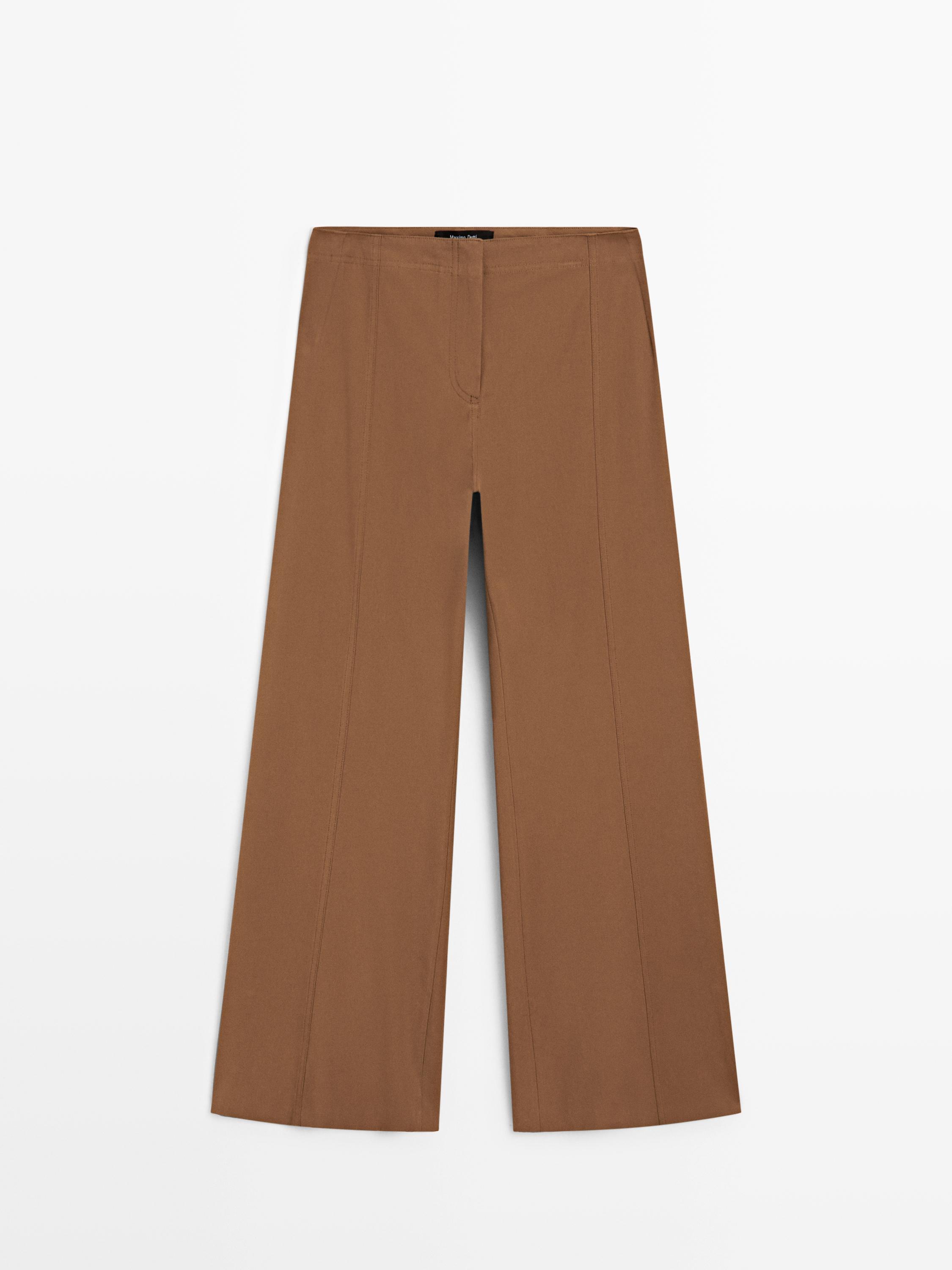 Front view of tobacco-colored flare fit pants with visible seams and a straight cut.