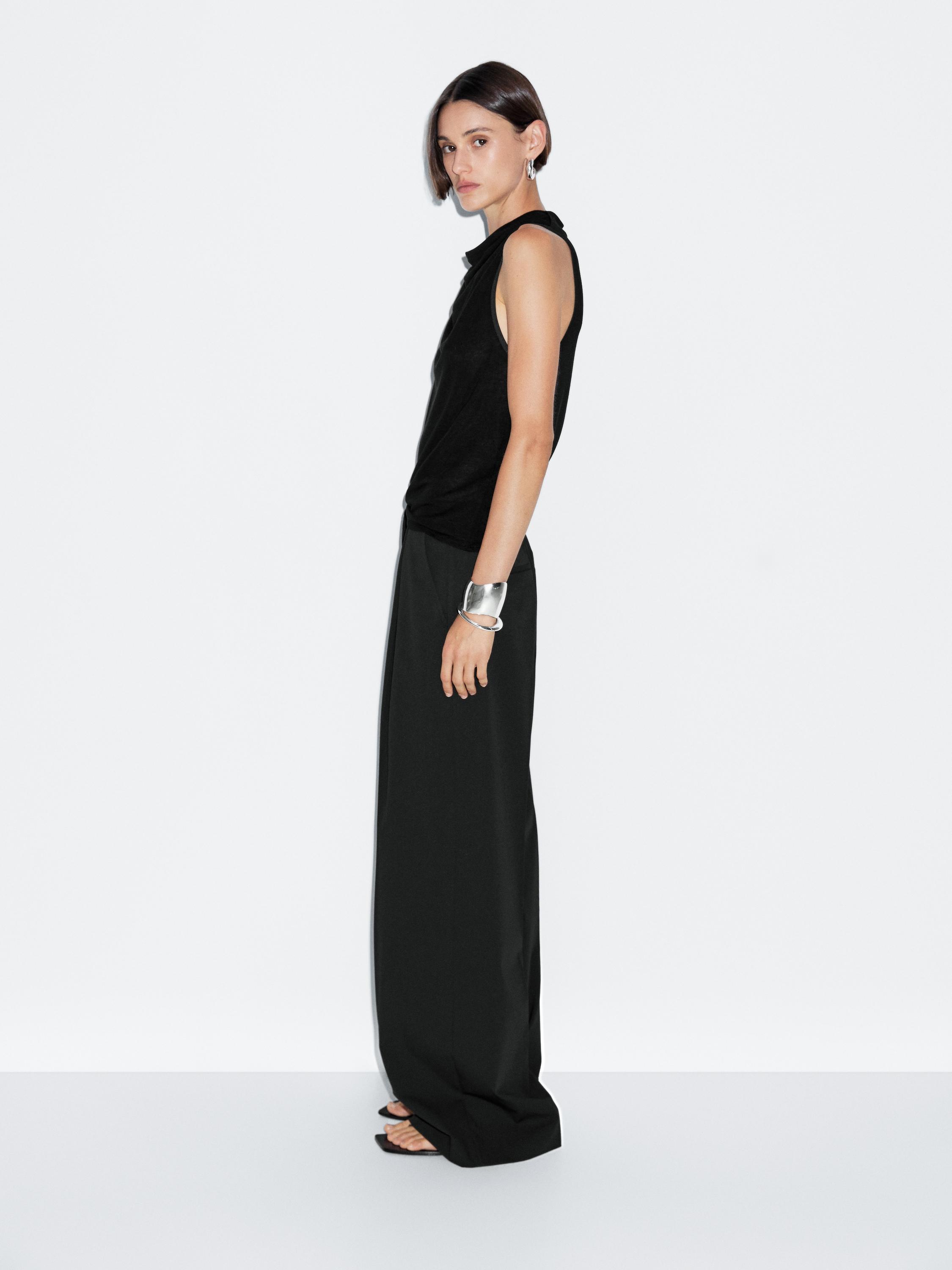Sleeveless top with draped neckline