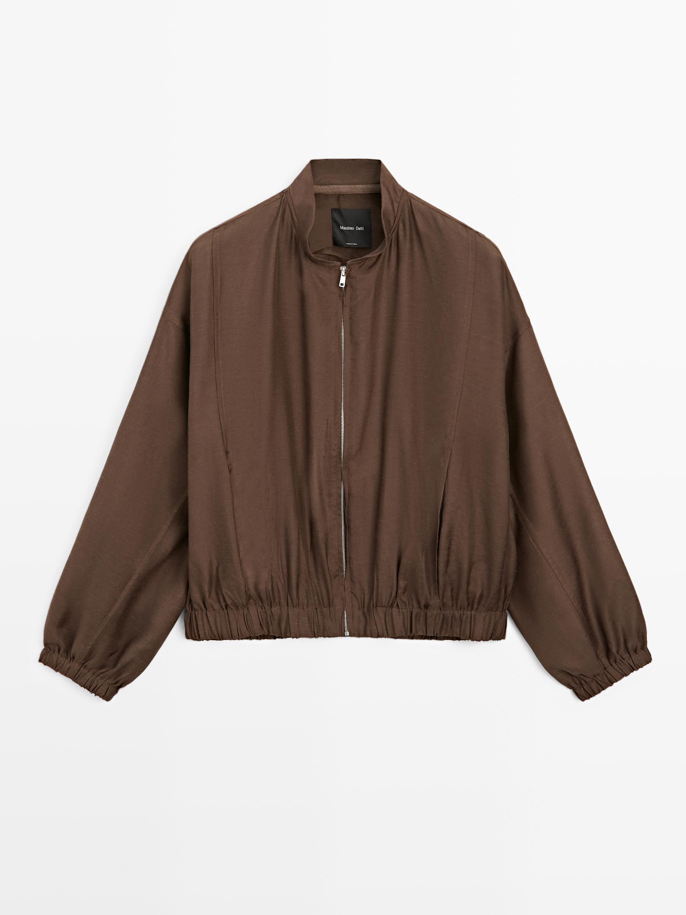Front view of brown bomber jacket with central zipper, high collar, and elastic cuffs.