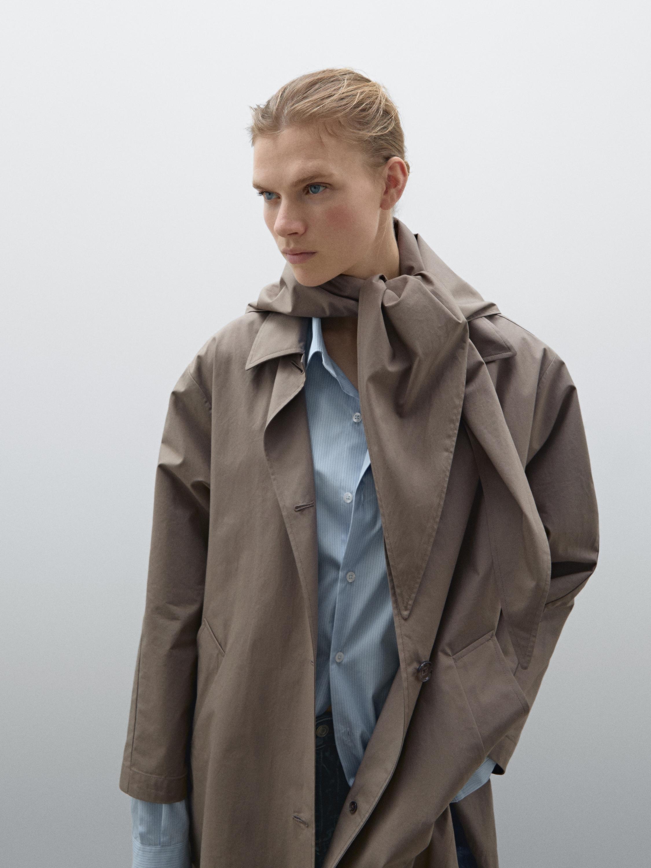 Trench coat with detachable scarf detail