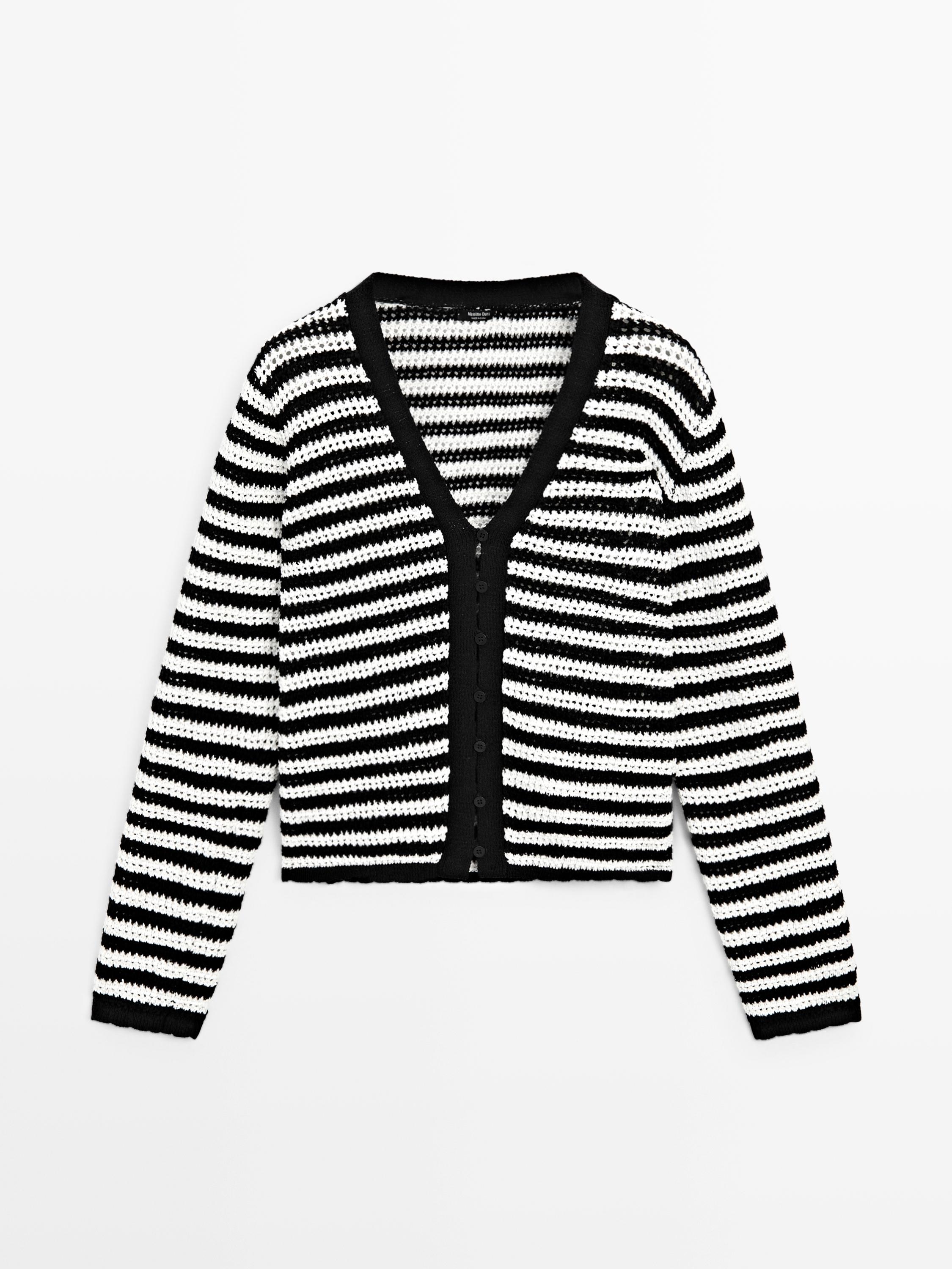 Front view of black knit cardigan with white stripes and button closure.