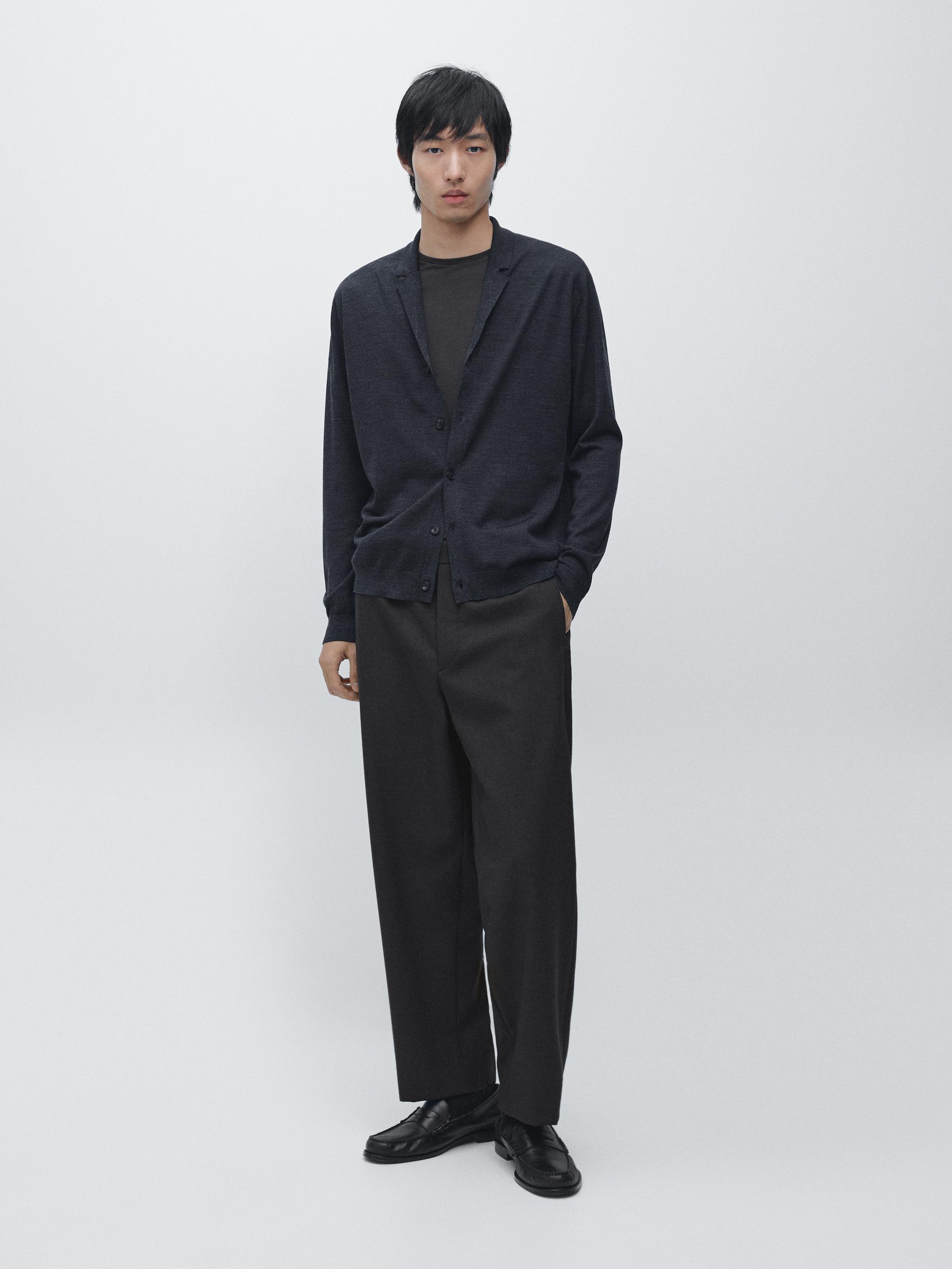 Dark navy cardigan set with lapel collar and buttons, black t-shirt, dark wide-leg pants, and black shoes.