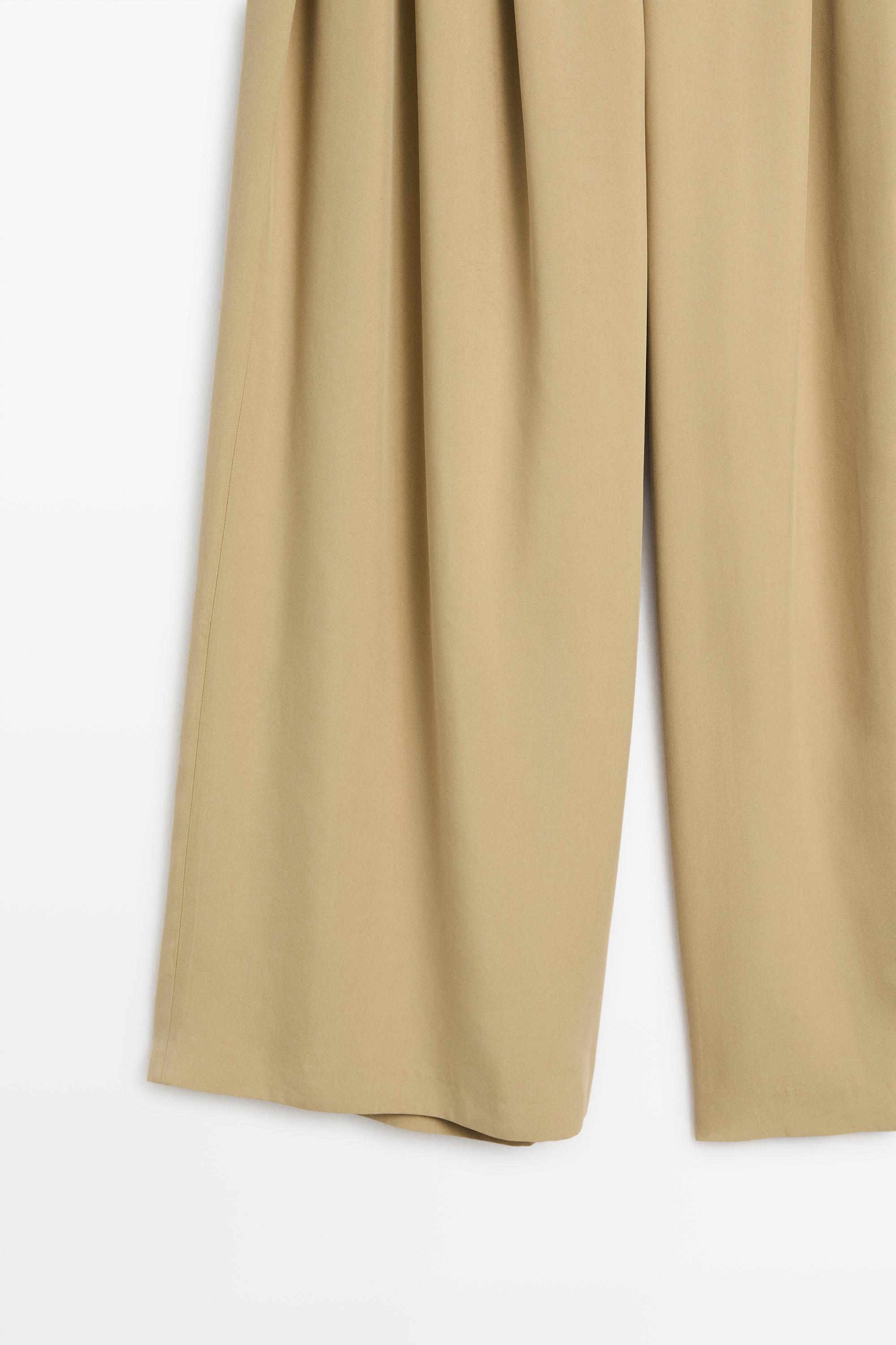 Flowing pleated pants with button detail — BEIGE