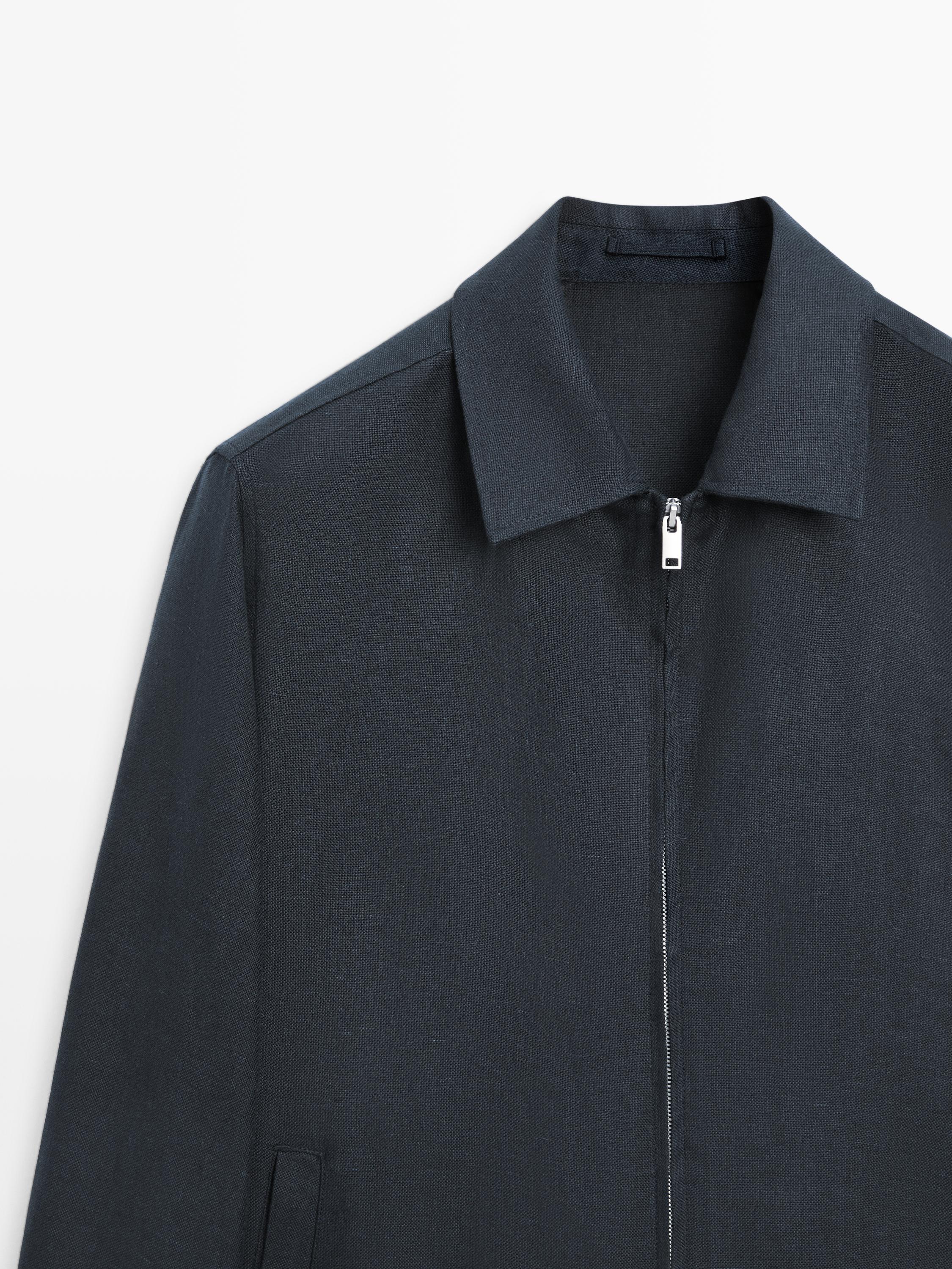 "Medium shot of a deep blue jacket with a front zipper and classic collar."