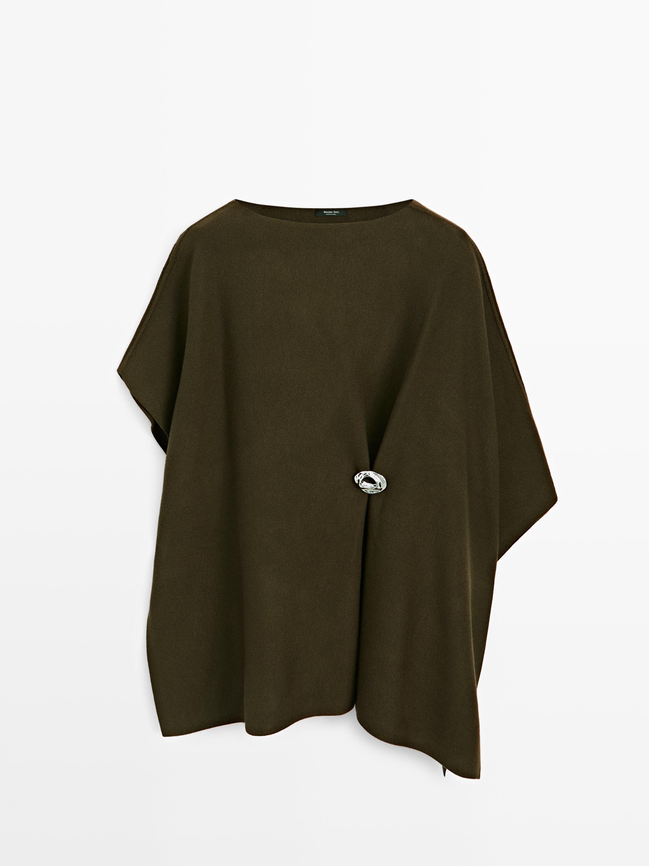 Knit cape with brooch detail