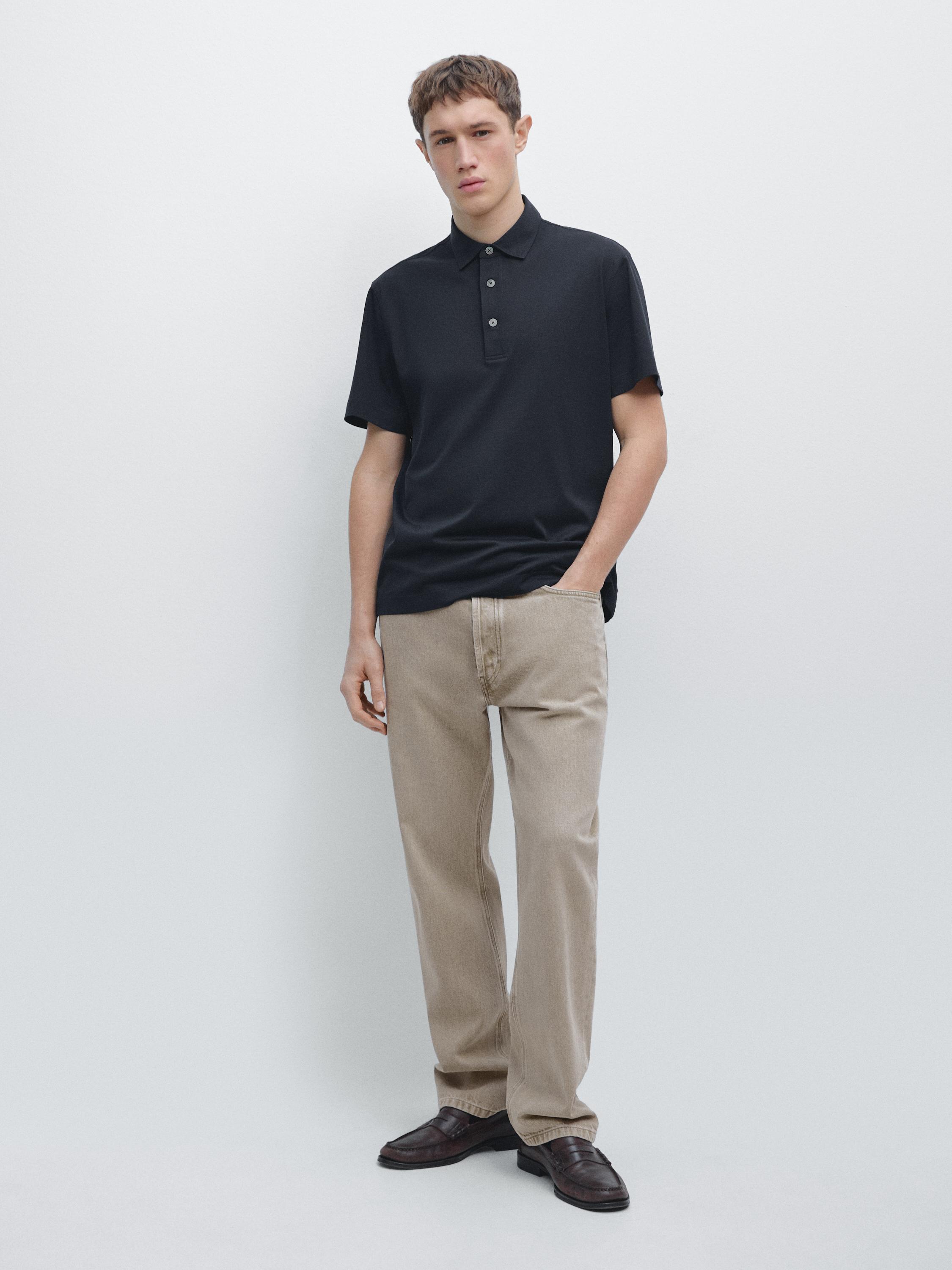 Navy blue short-sleeved polo set with buttons and straight beige pants.