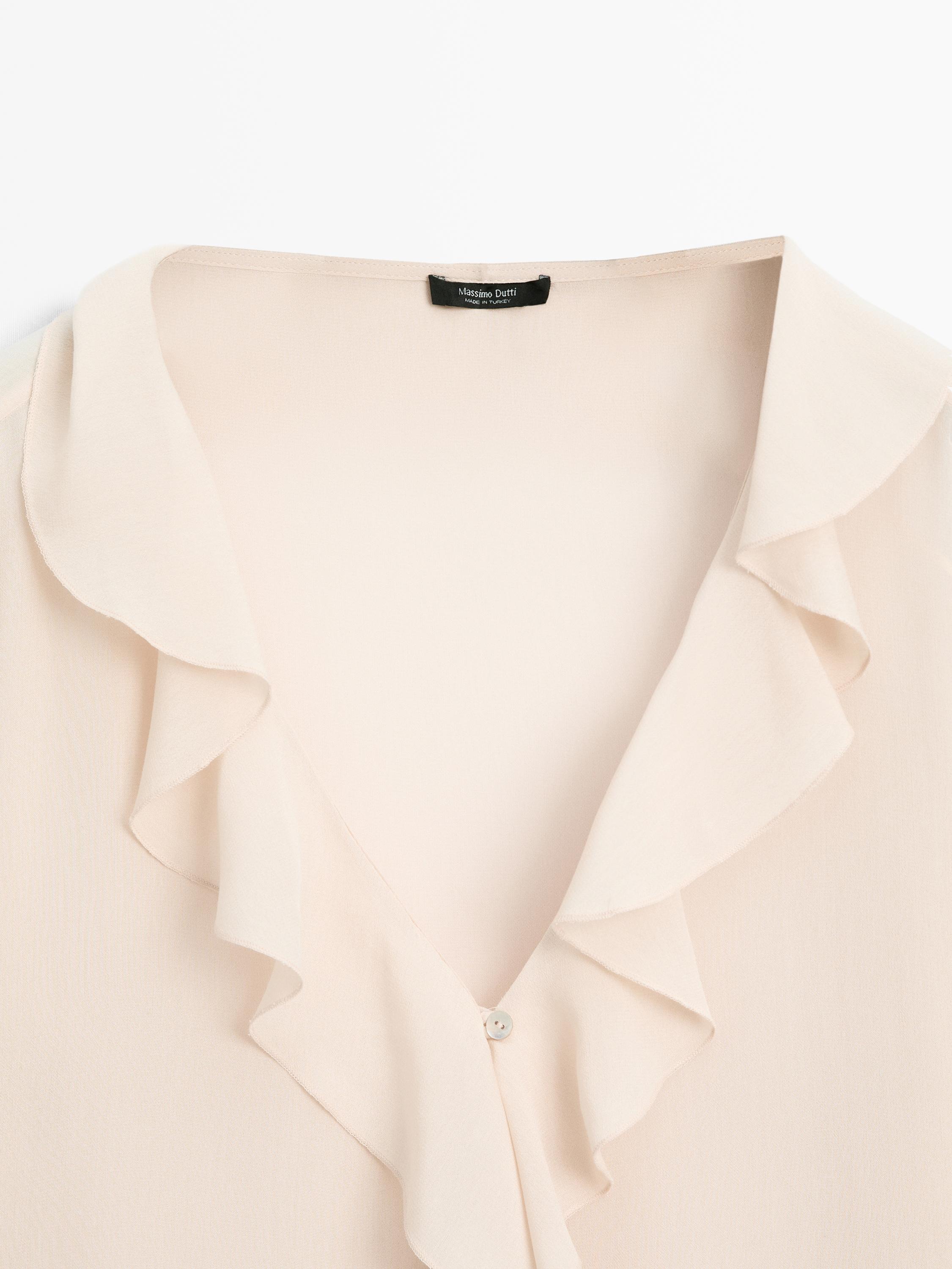 Ruffled blouse with asymmetric hem