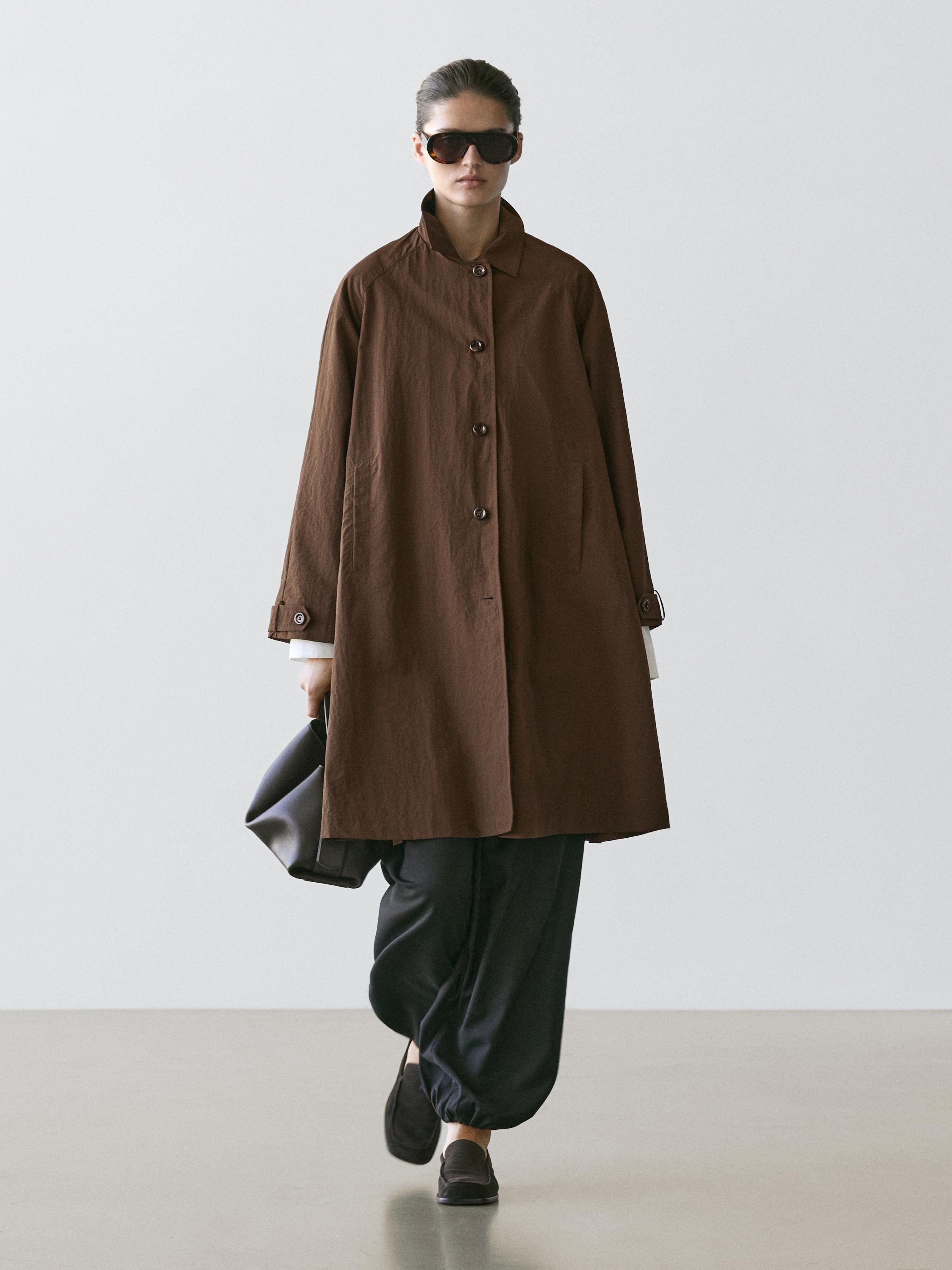Brown coat set with a high collar and buttons, dark pants, and black shoes.