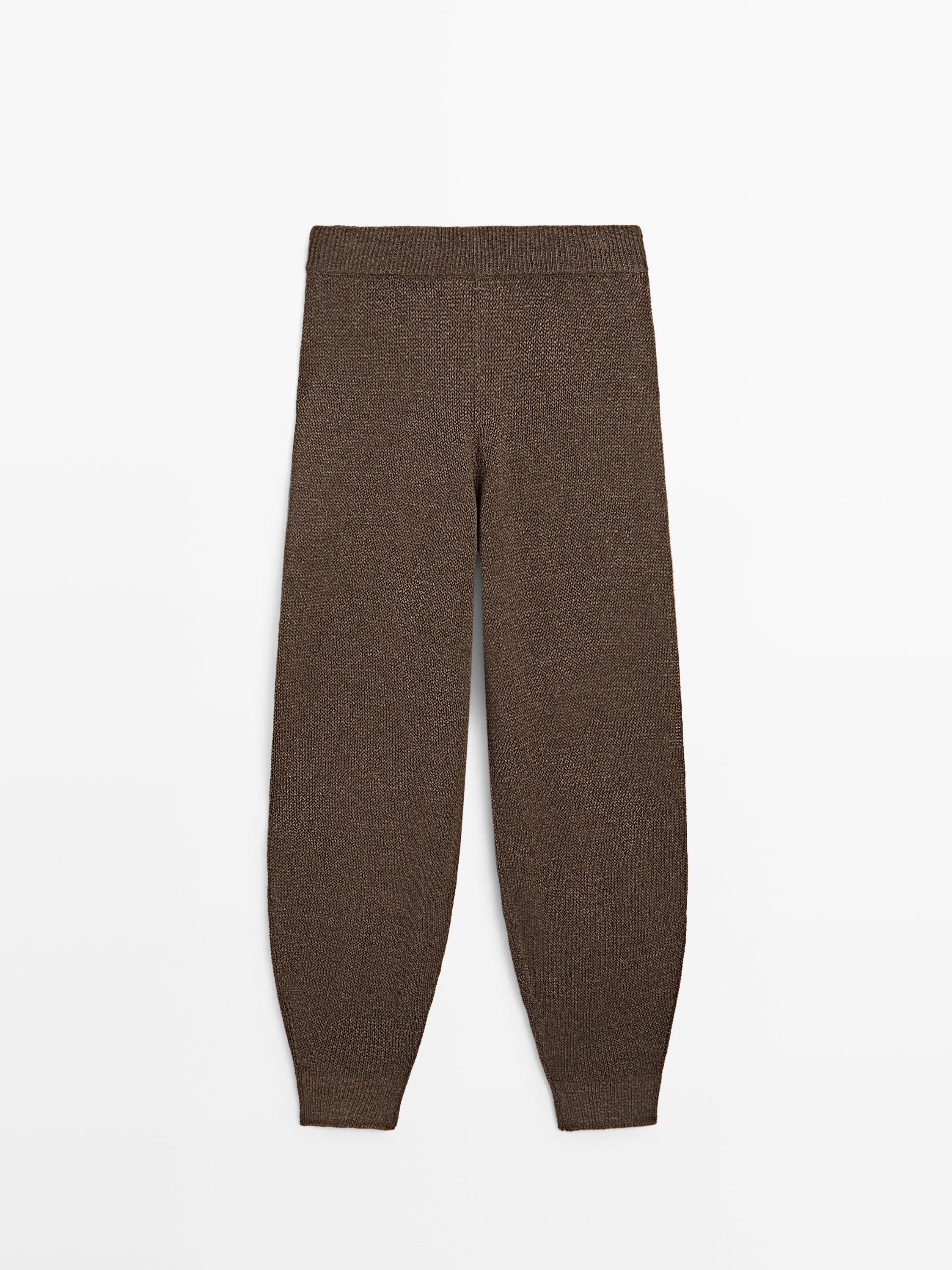 Front view of soft brown pants with an elastic waistband and fitted cuffs.