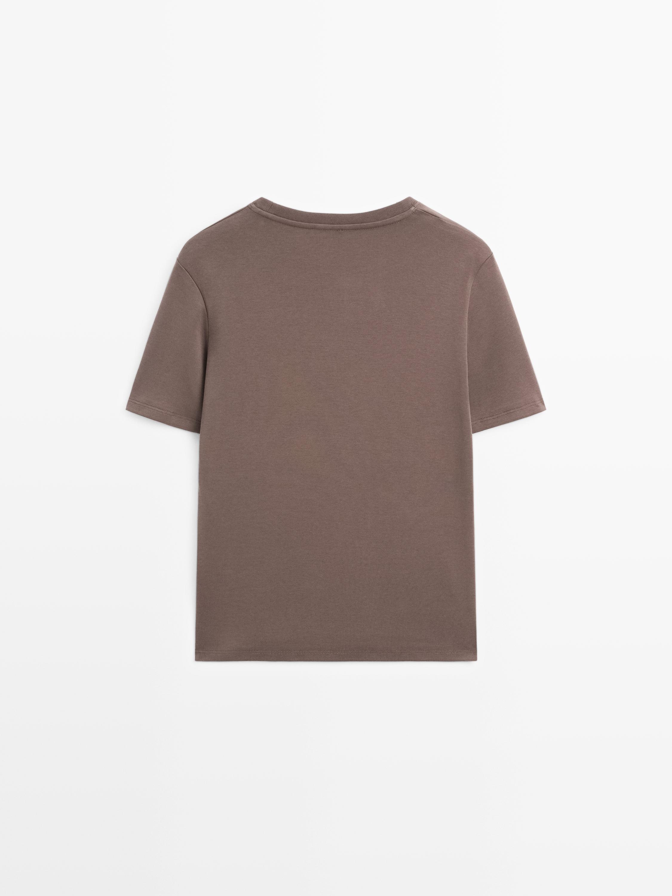 Вид сзади на норковую футболку с короткими рукавами, прямого кроя и круглым вырезом.