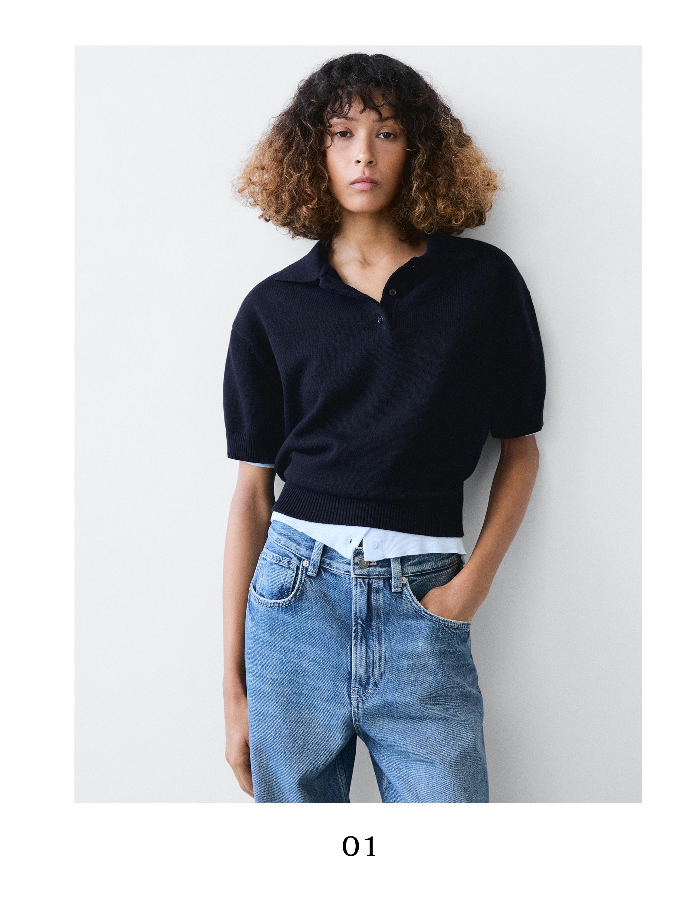 Navy blue knit polo sweater with short sleeves and blue jeans with front pockets.