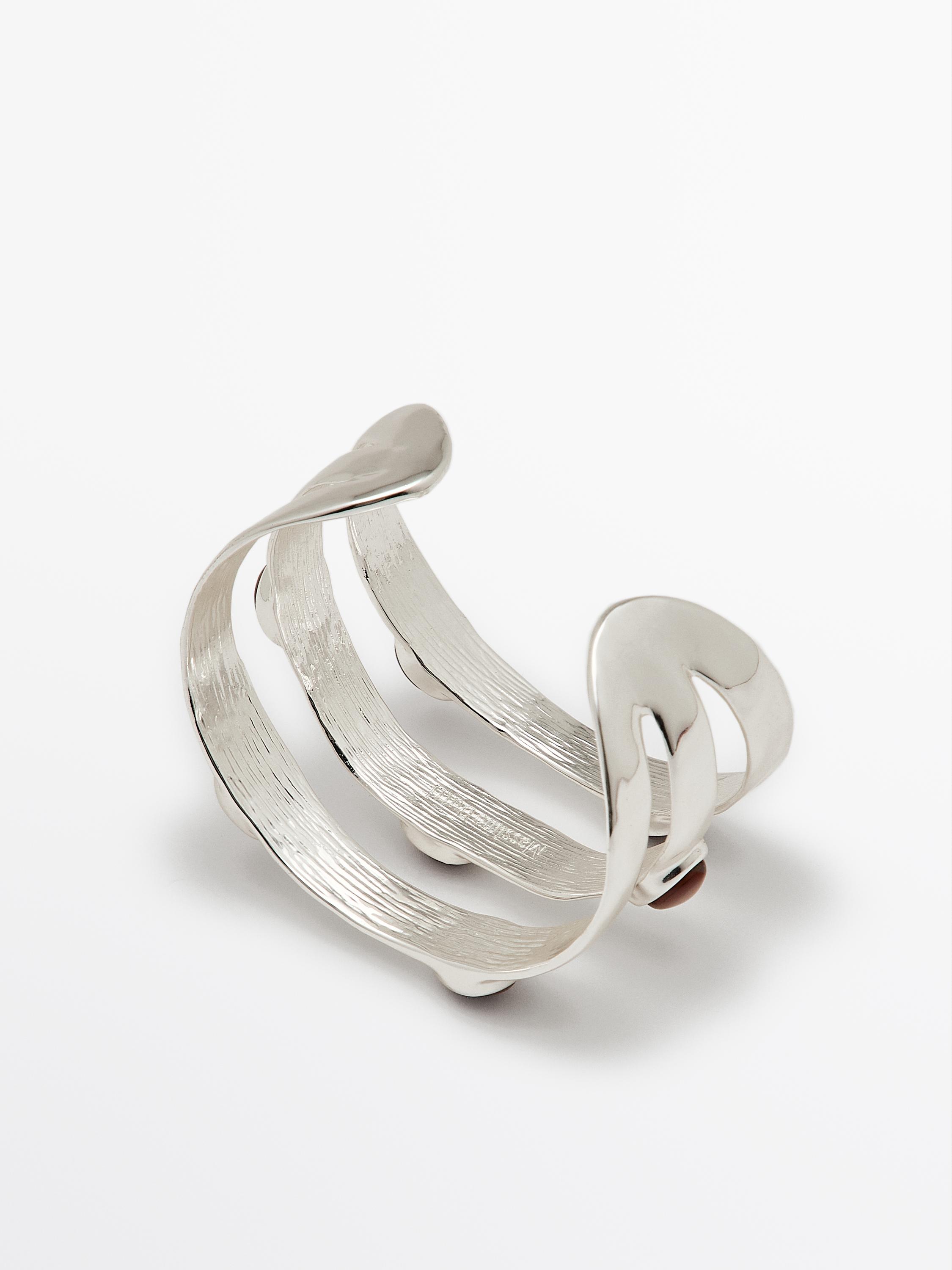 Wide bracelet with encrusted details