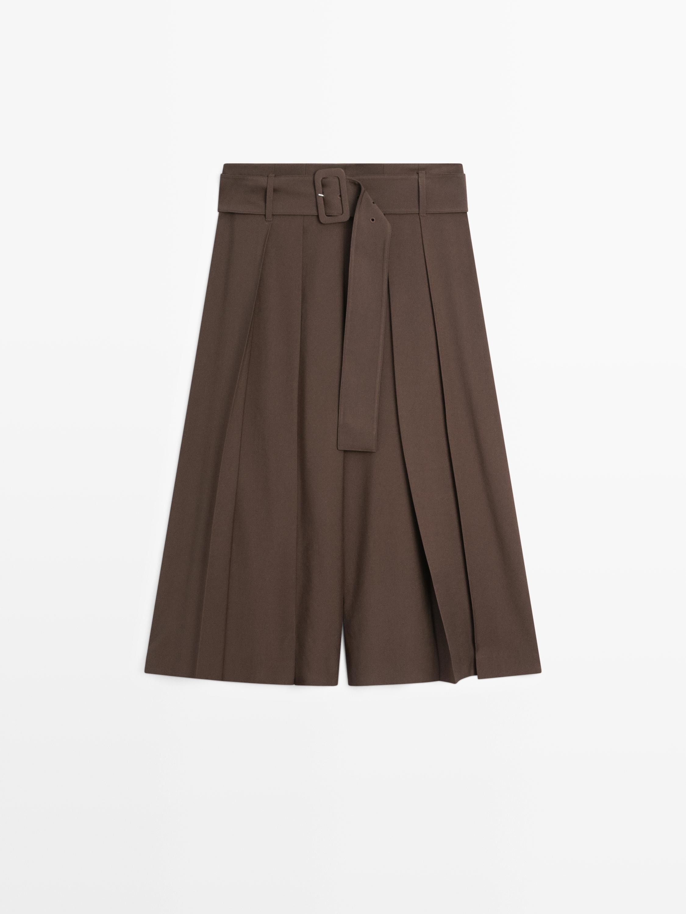 Front view of a brown midi skort with pleats, a buckle belt, and a hidden closure.