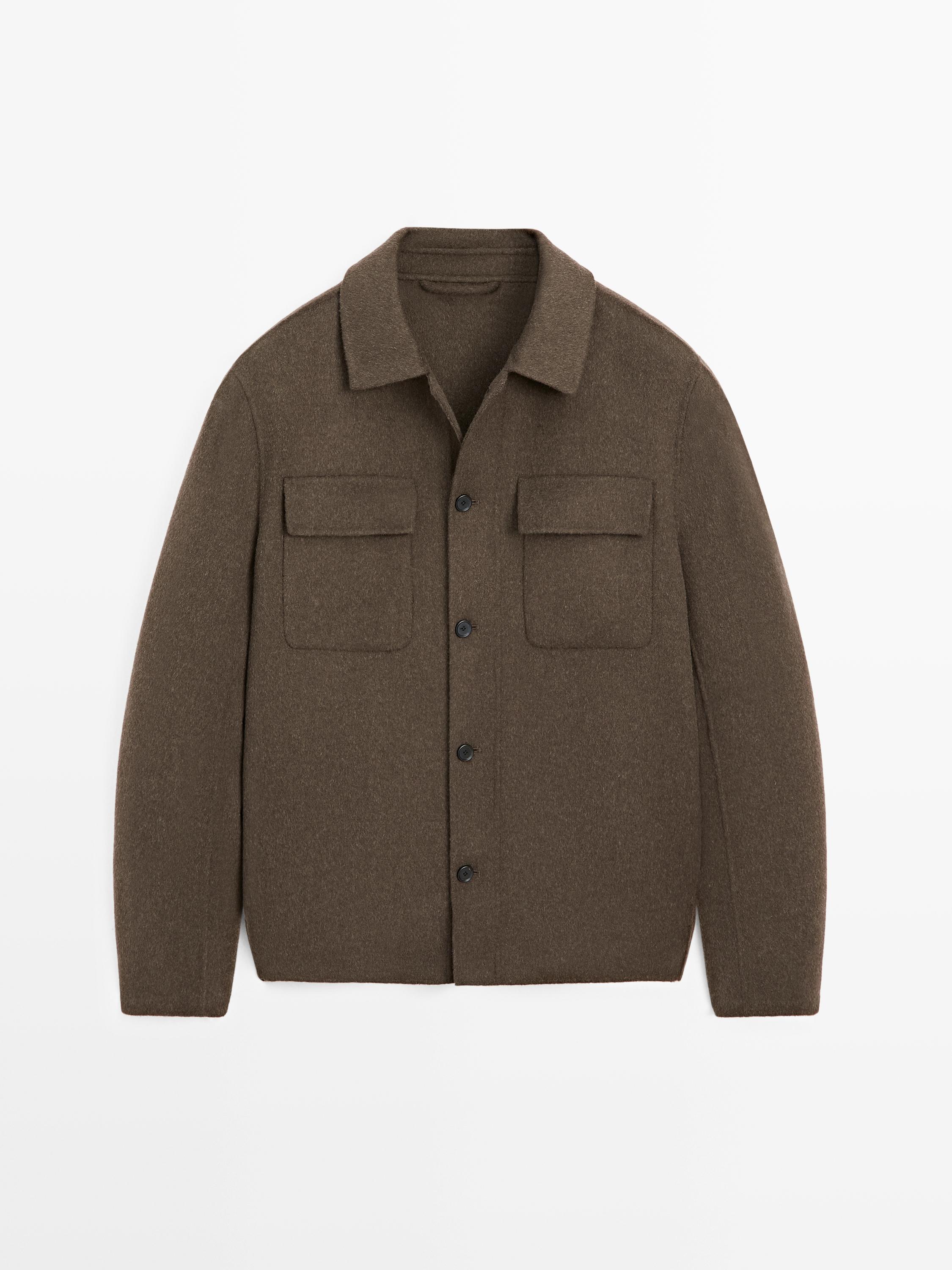 Front view of a khaki overshirt with front flap pockets and button closure.
