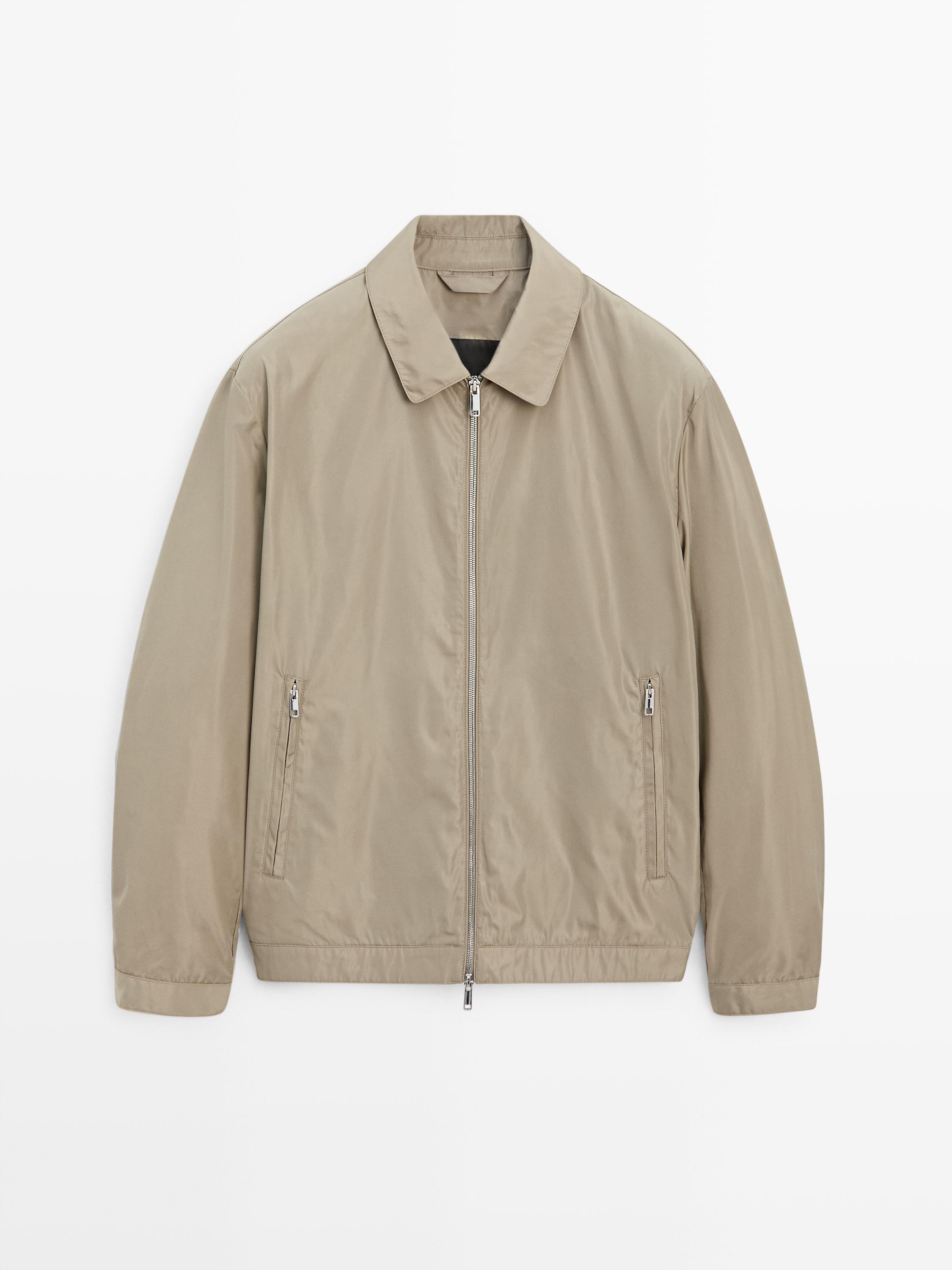 "Front view of a mink jacket with a central zipper and side pockets with closure."