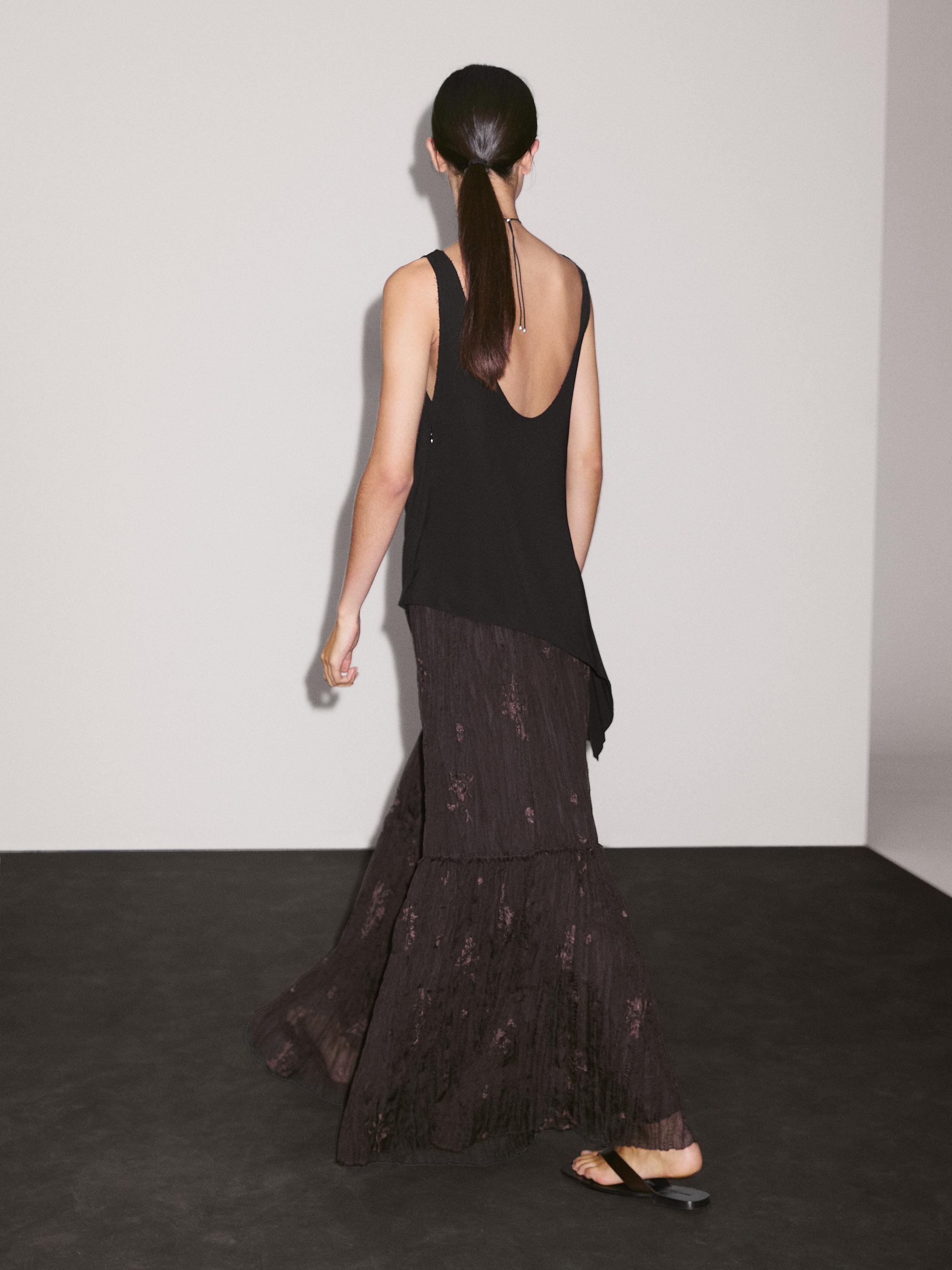 Long pleated skirt with embroidered detail