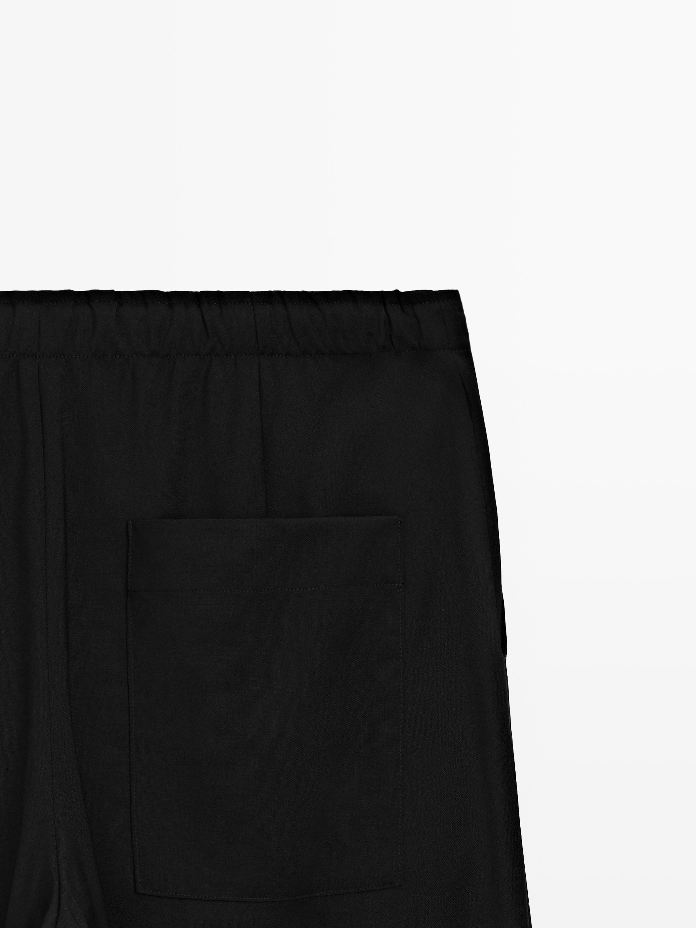Wool sarouel trousers with tie detail — BLACK