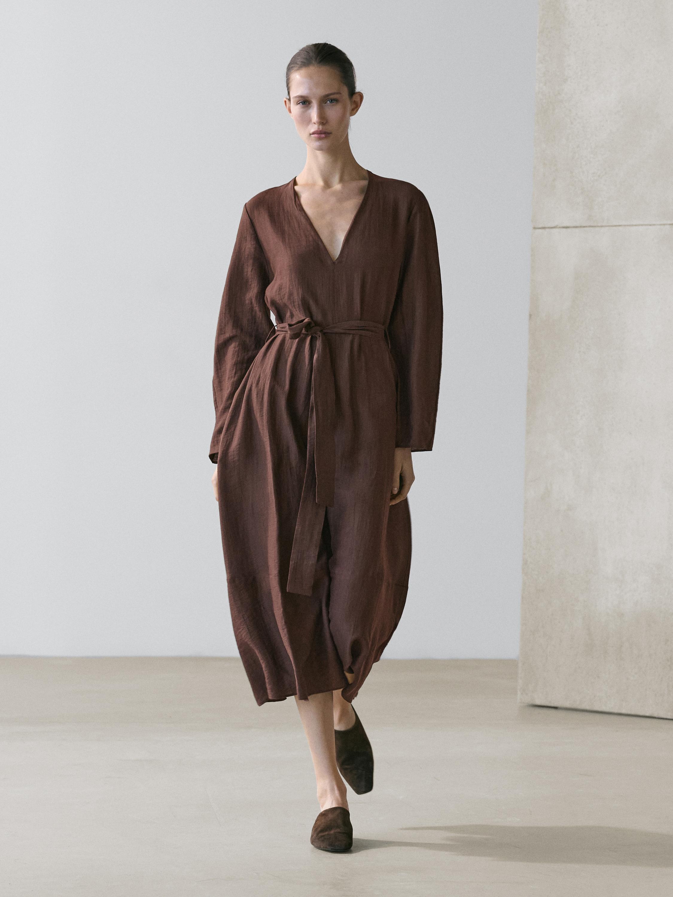 Flowy brown midi dress set with belt, V-neck, and long sleeves.