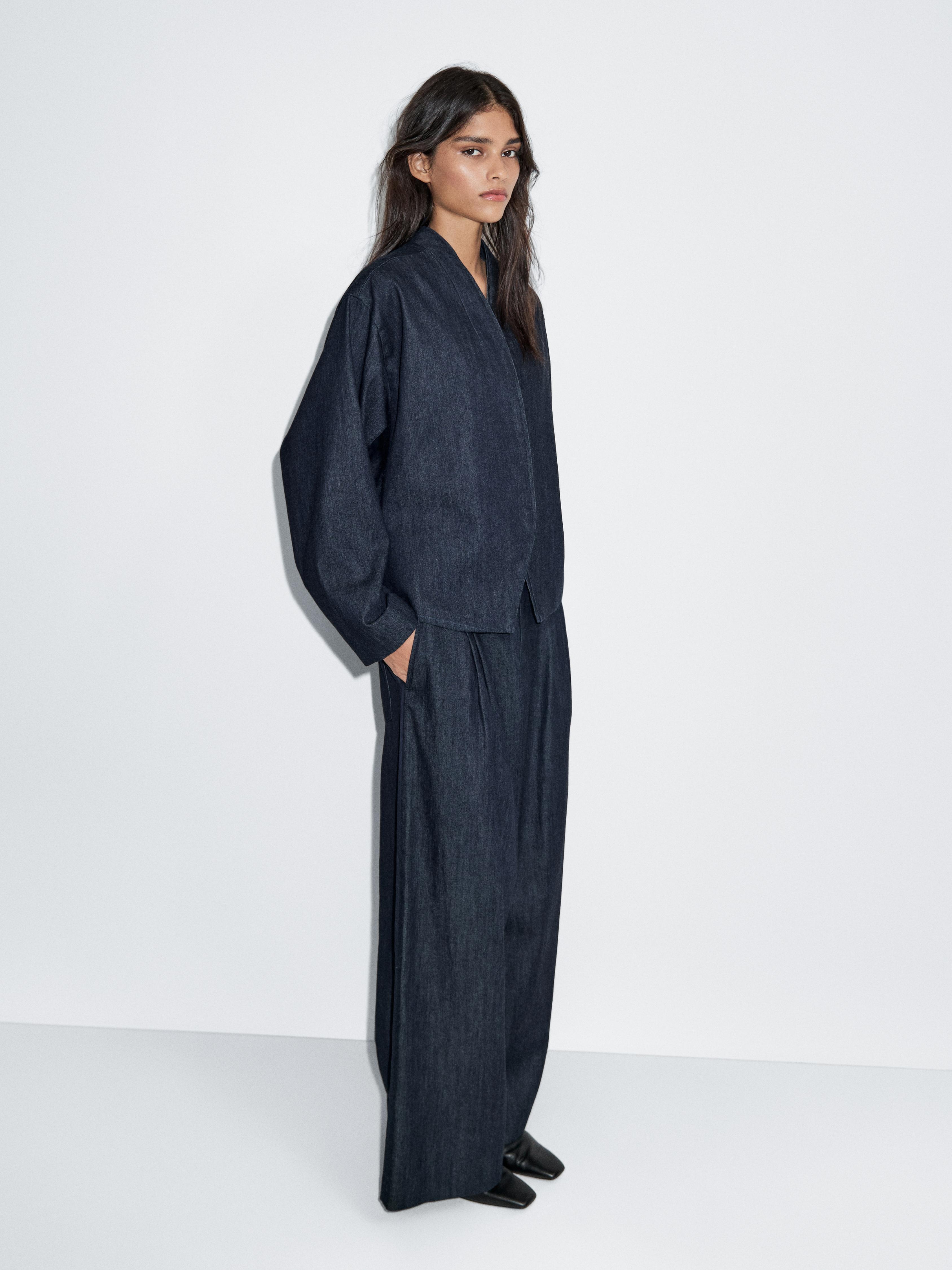 جينز بساق عريضة وتفاصيل بكسرات