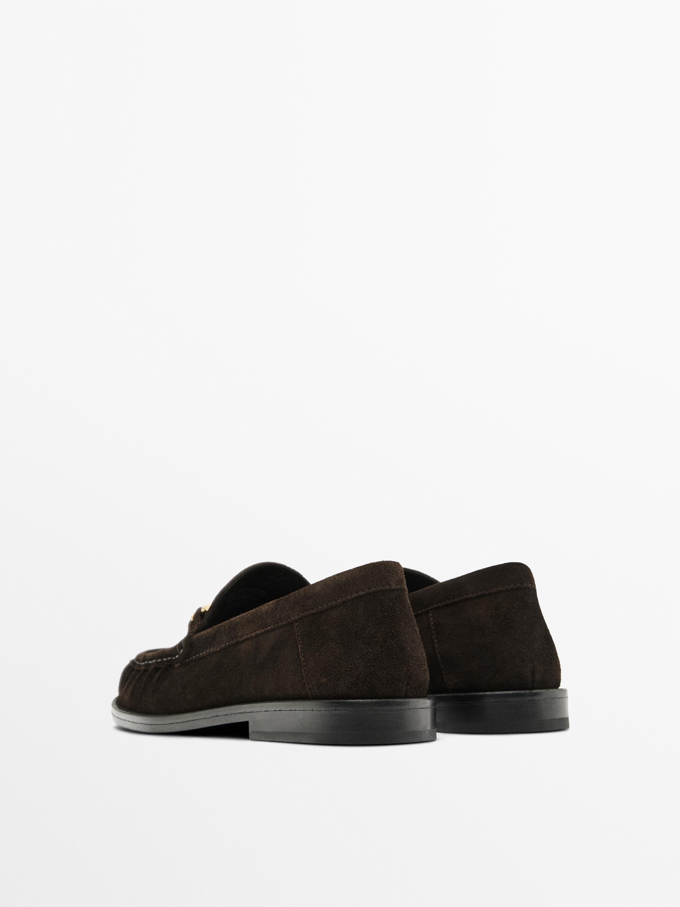 Split suede loafers with metal appliqué
