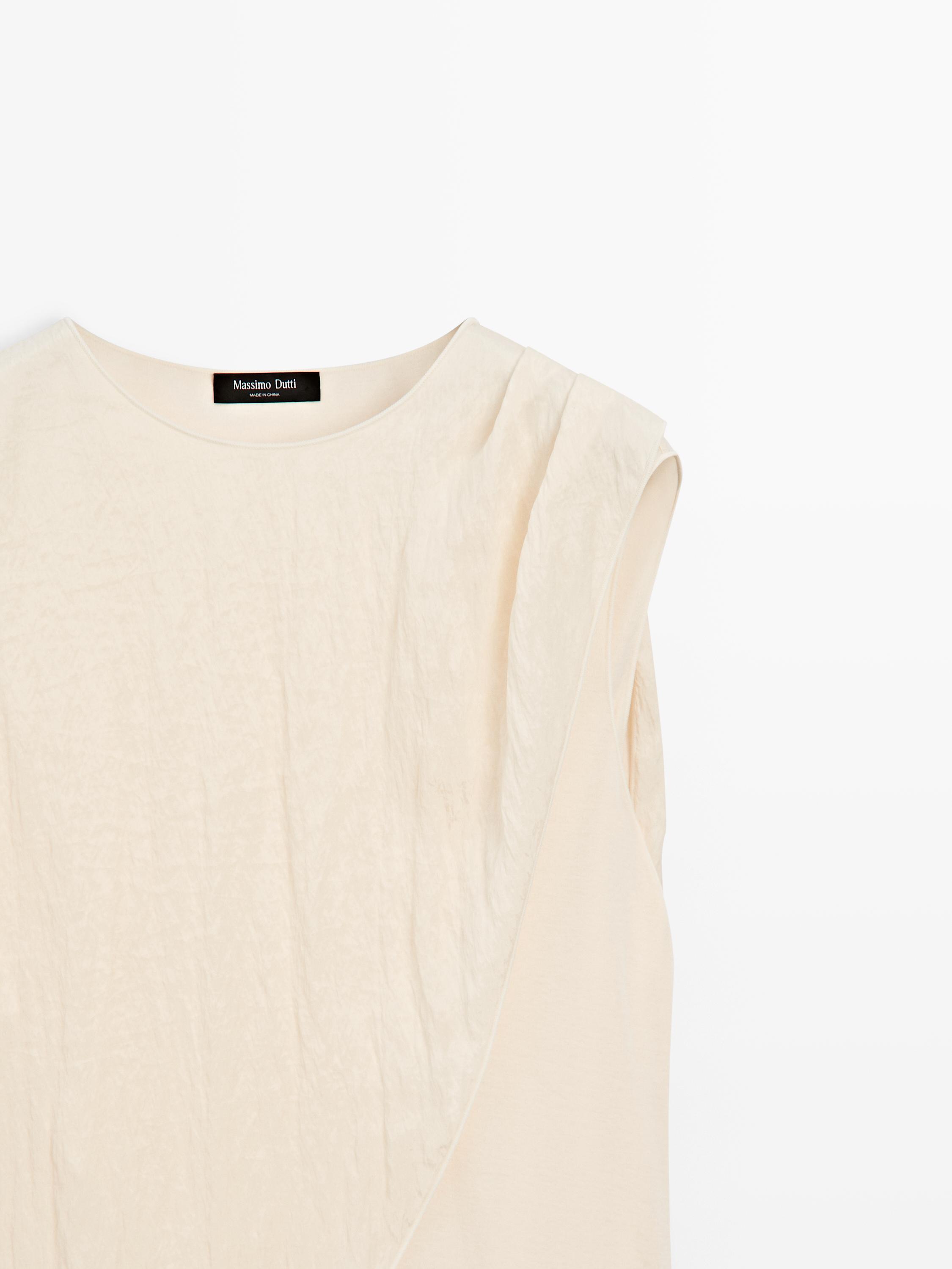 Cross-over top with scarf detail on the shoulder