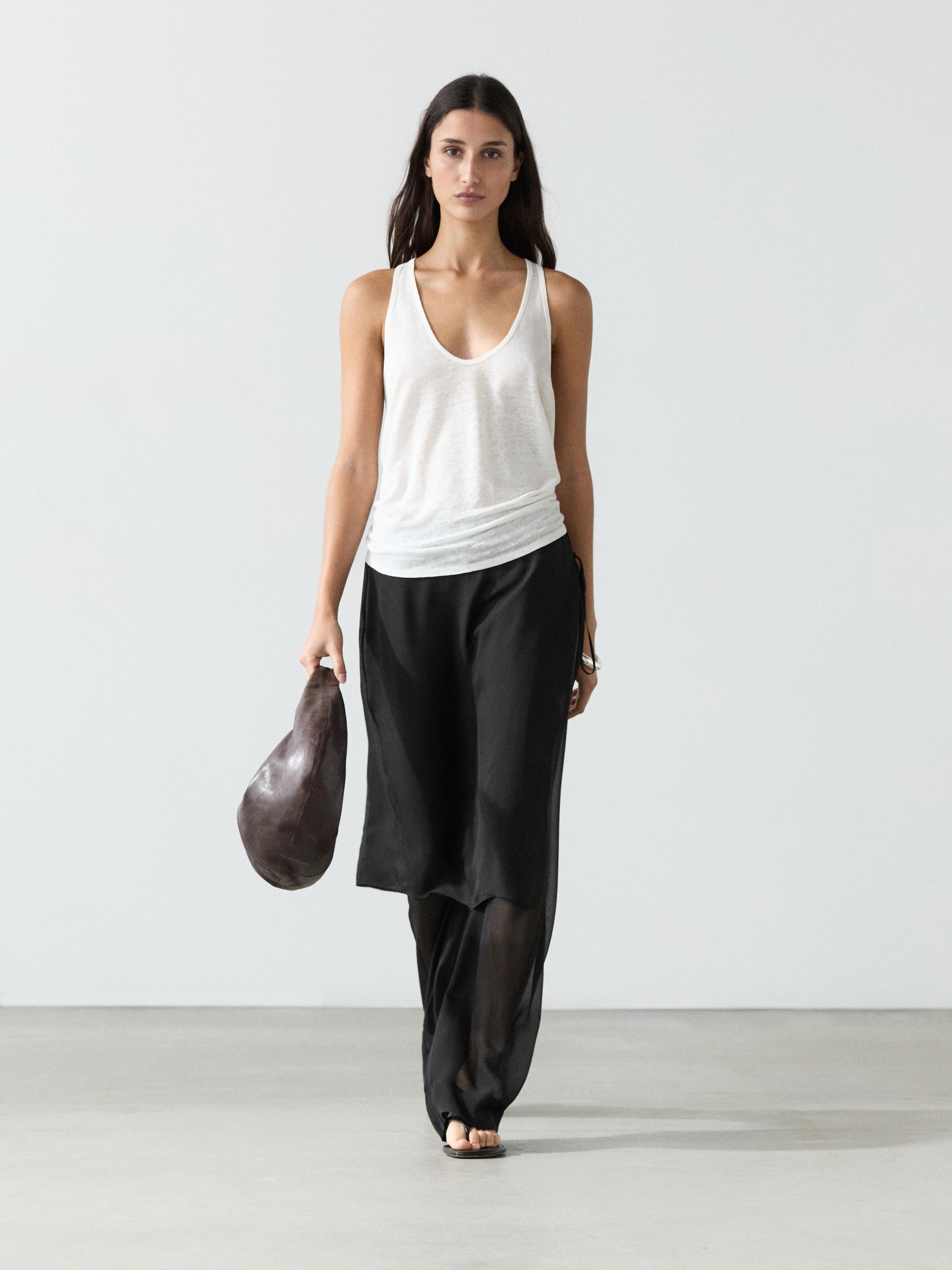 Long black skort set with a white sleeveless top.