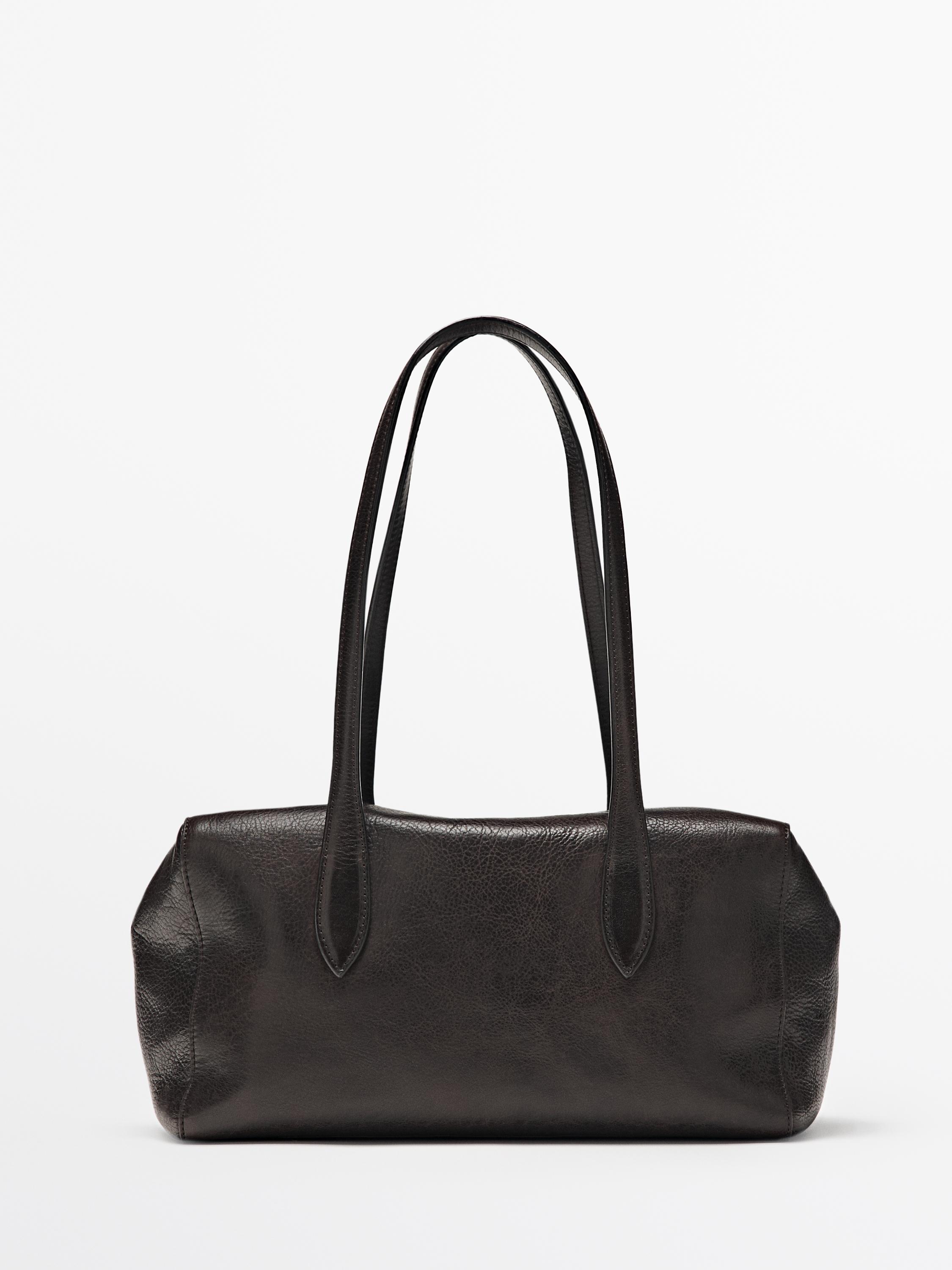 Front view of a brown handbag with long handles and a rectangular design.