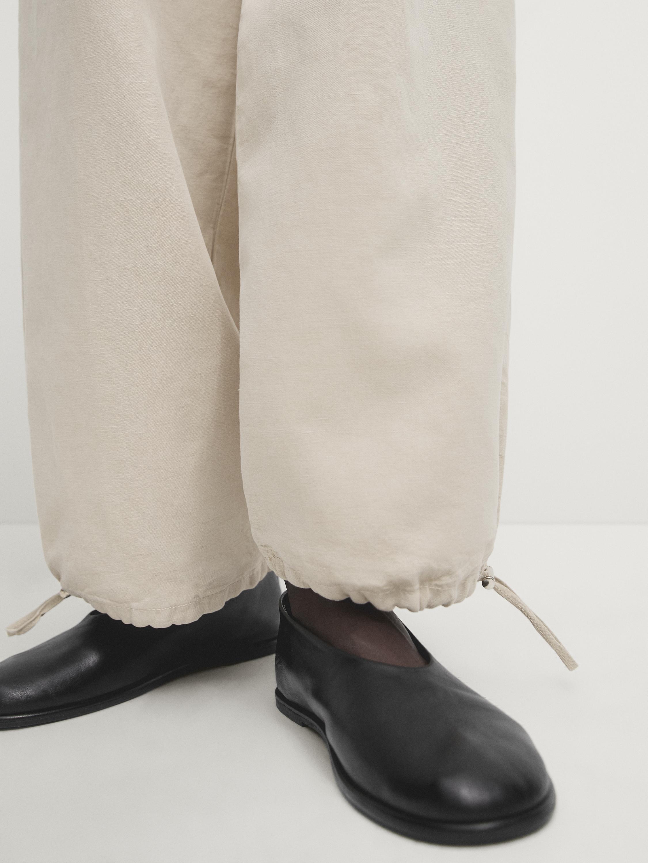 Trousers with elasticated waistband and adjustable hems