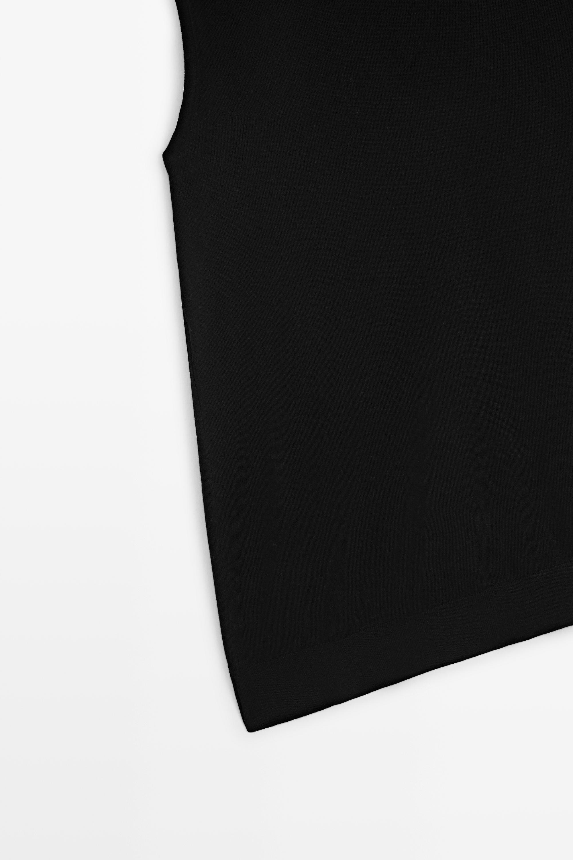 Asymmetric hem turtleneck top — BLACK