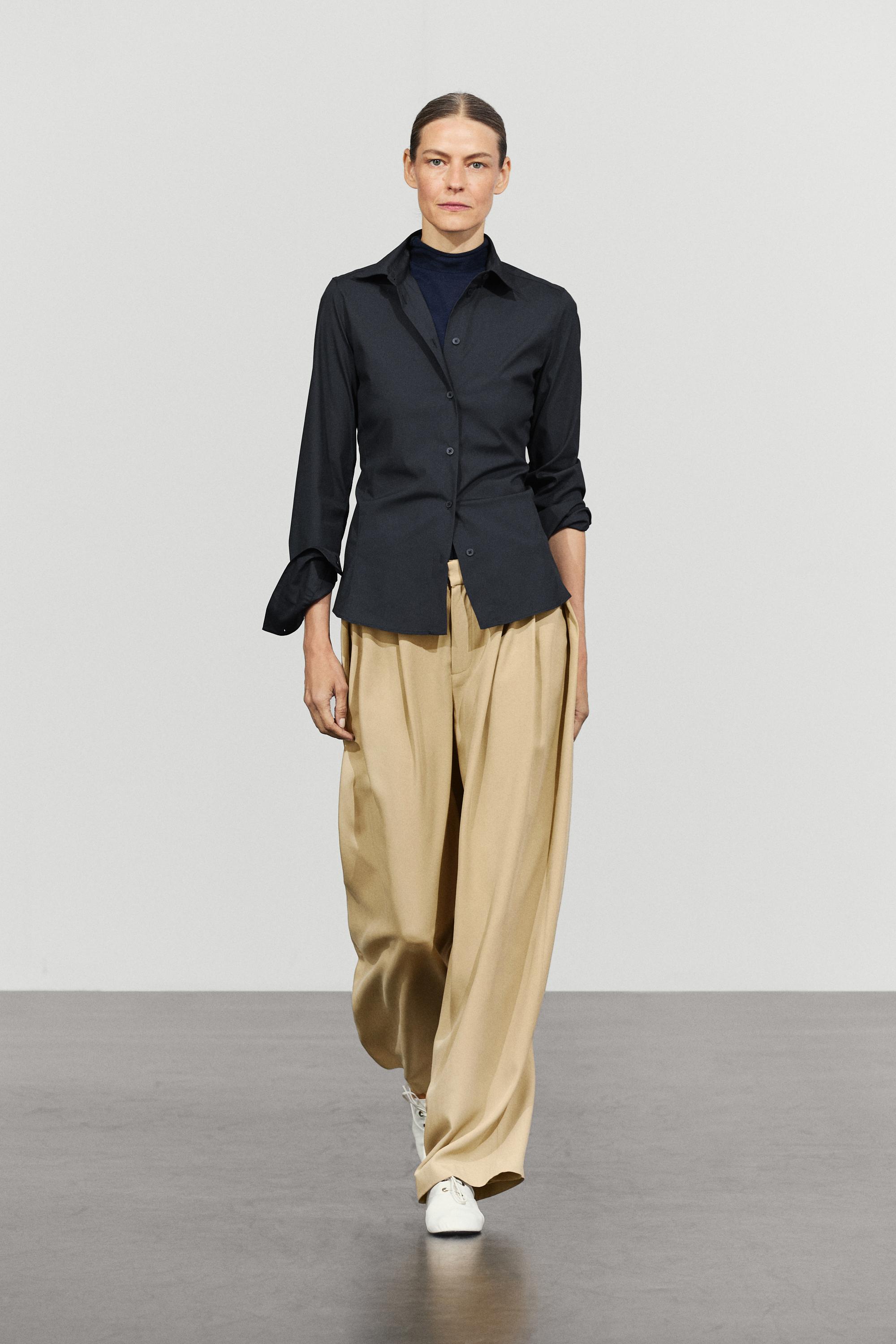 Flowing pleated pants with button detail