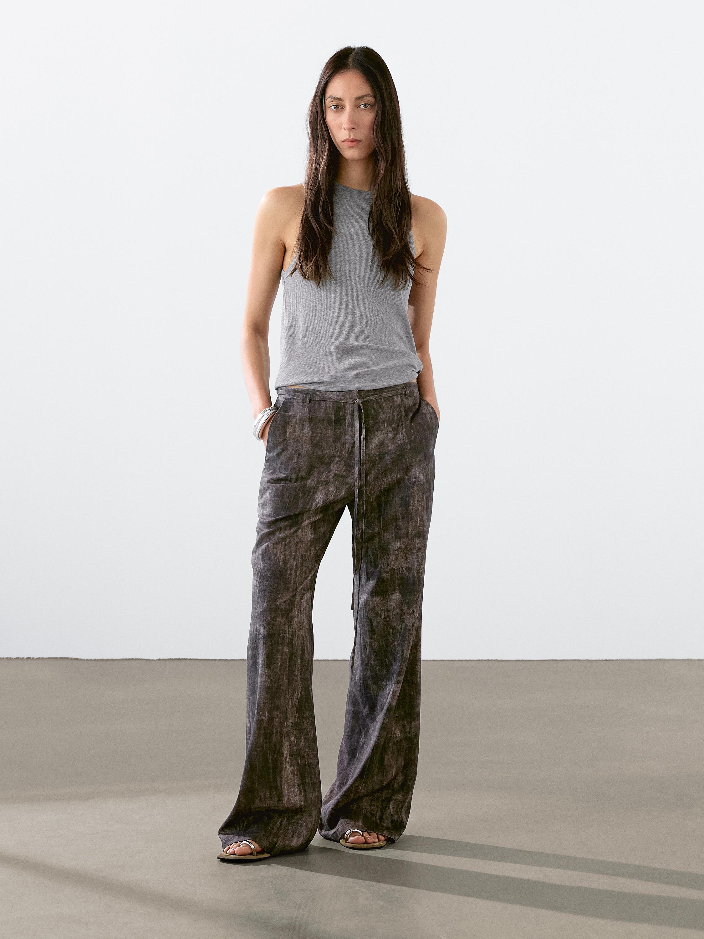 Distressed-effect flared trousers