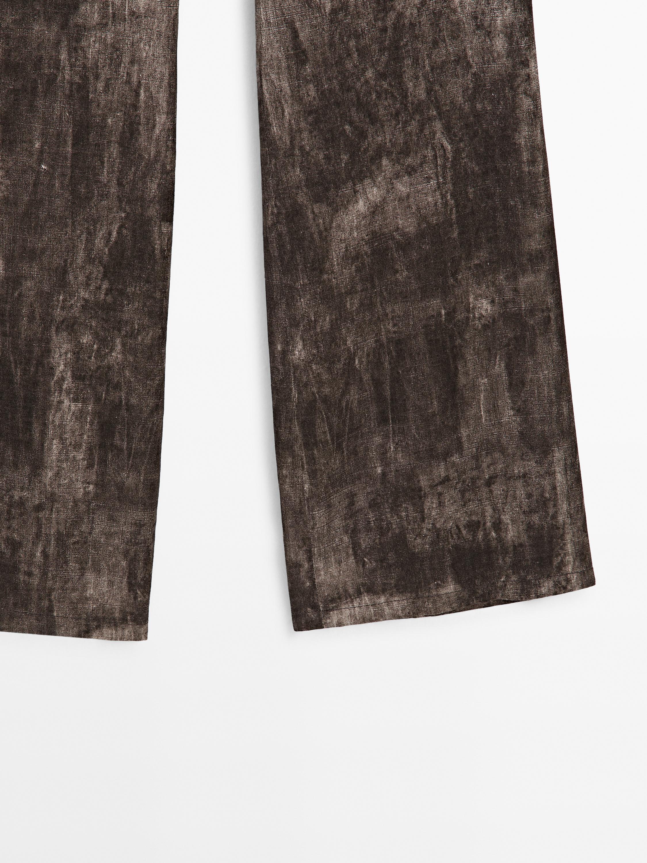 Distressed-effect flared trousers
