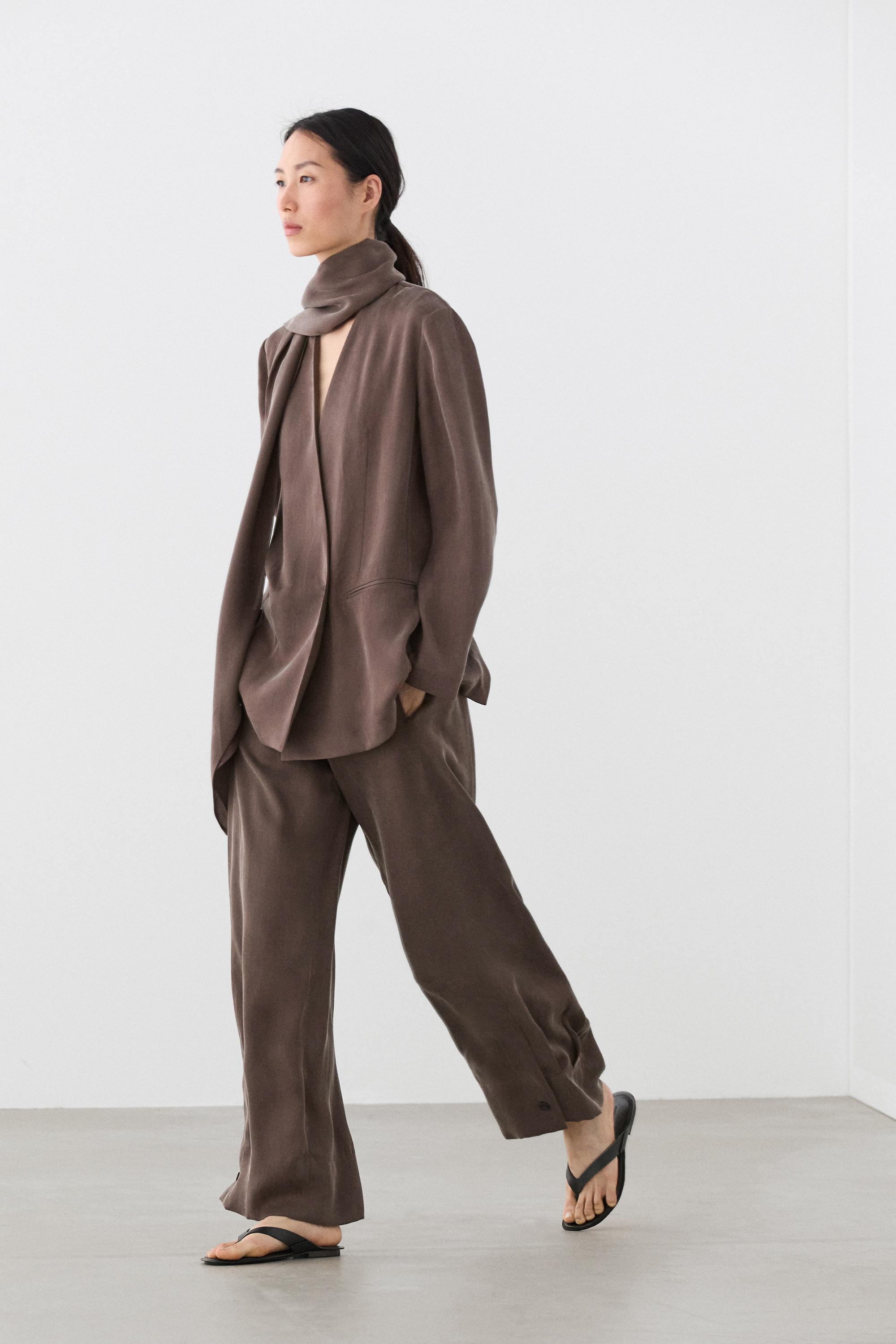 Total look flowing trousers with buttoned hems — PLUM