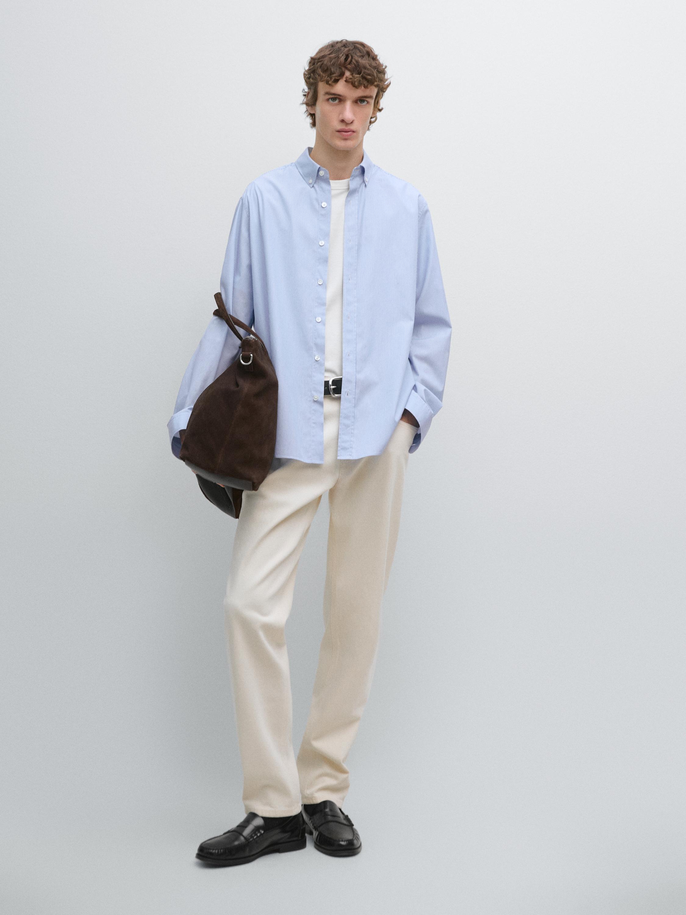 Sky blue long-sleeved button-down shirt and beige pants set.