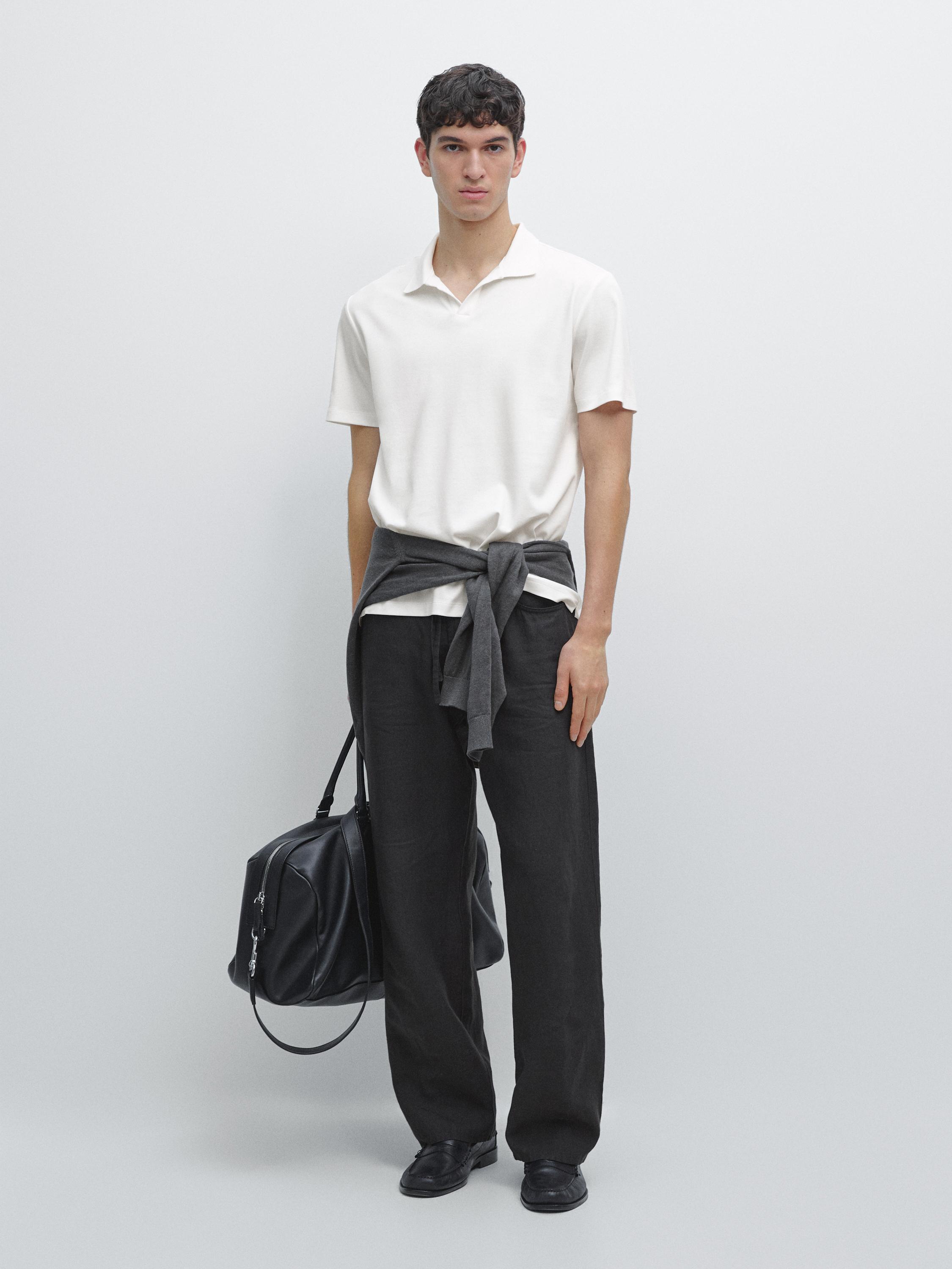 short-sleeve polo shirt and wide-leg black pants set, with a gray sweater tied around the waist.