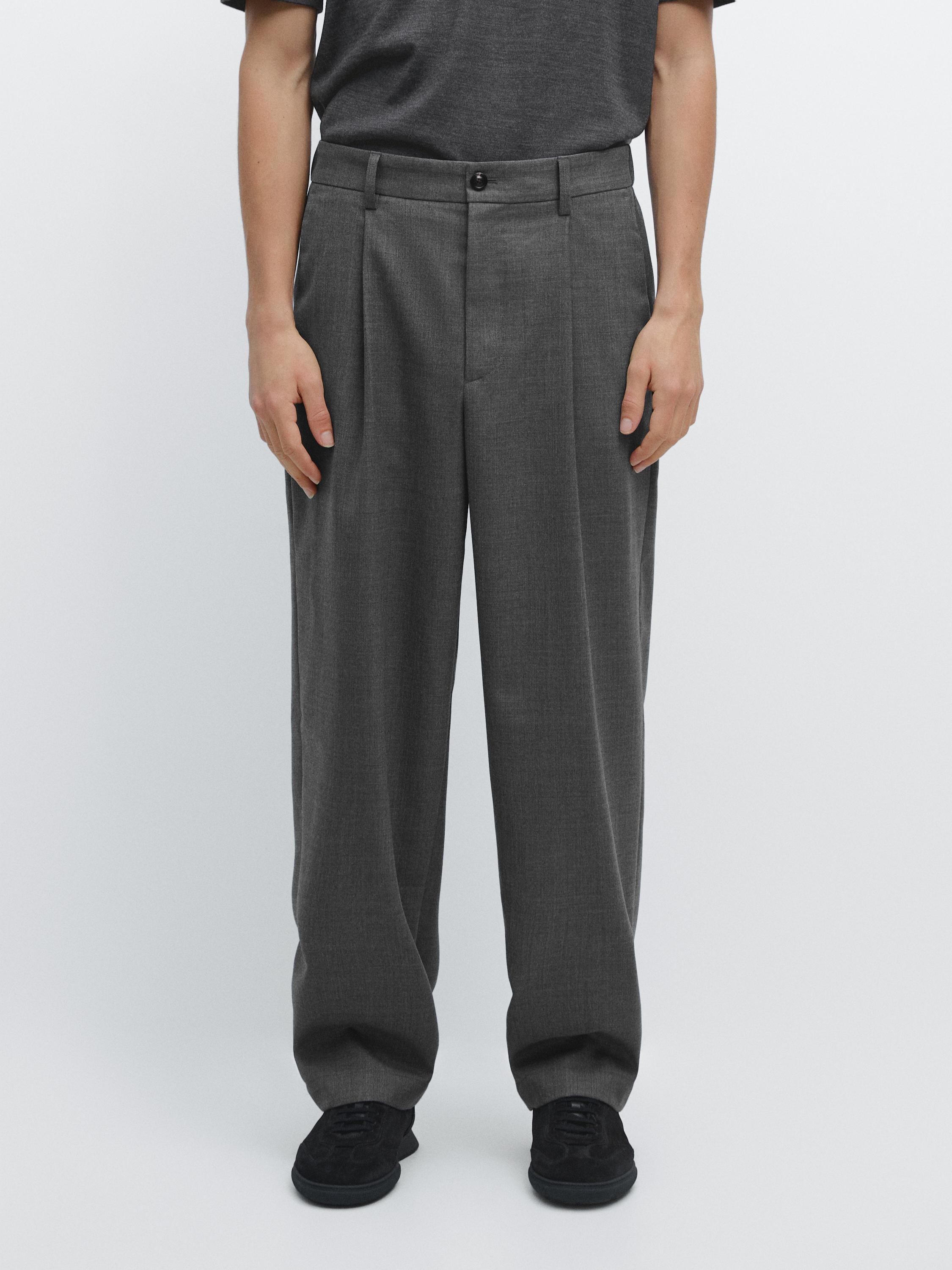 Gray relaxed fit pants set with pleats, side pockets, and a front button.