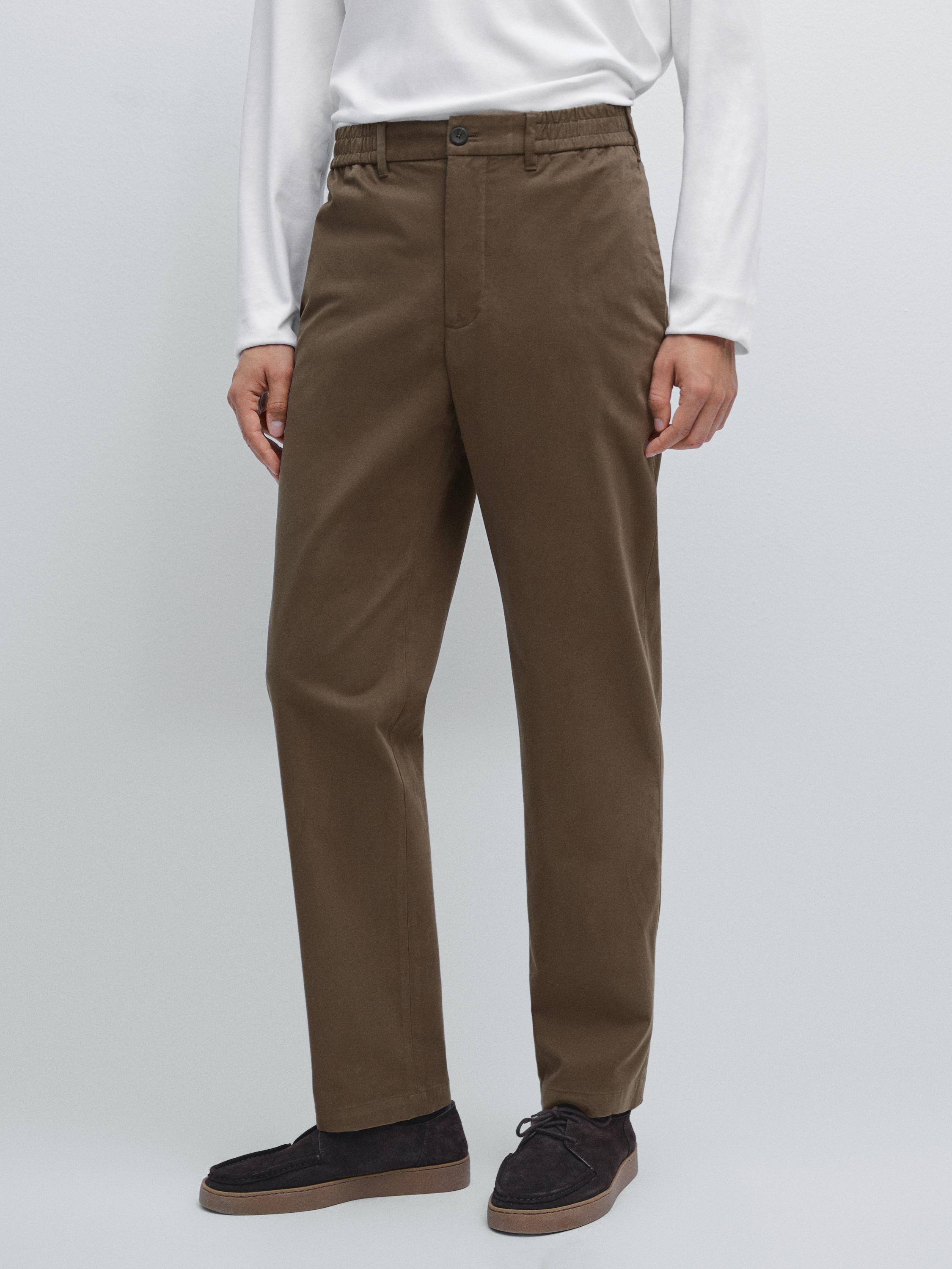 Brown jogger pants set with elastic waistband and front button, side pockets, straight leg.