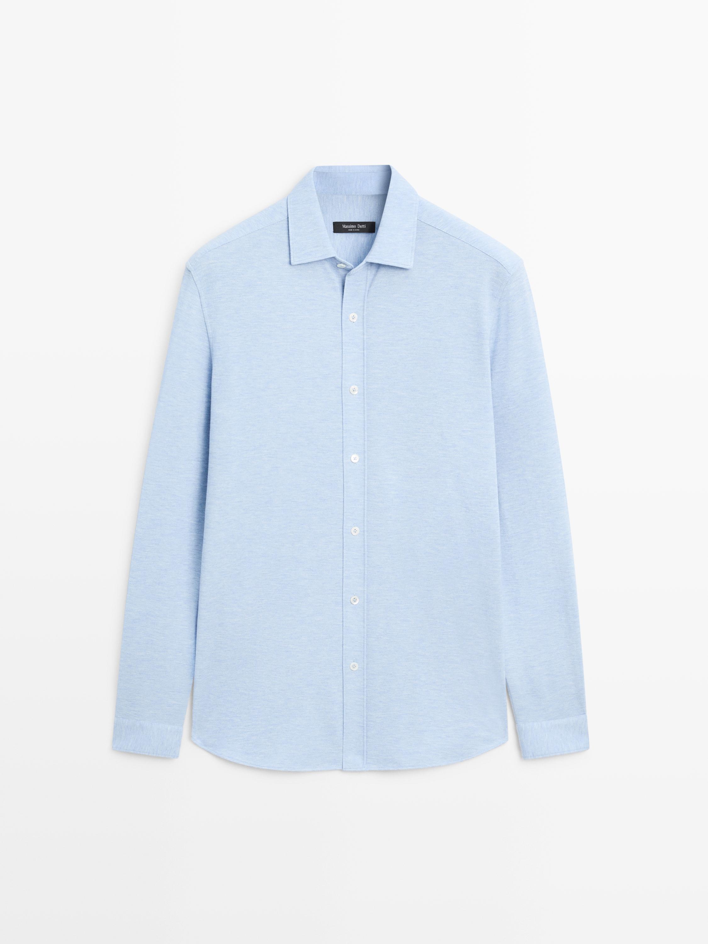 Front view of a light blue, long-sleeved, regular-fit shirt with a central button placket and a classic collar.