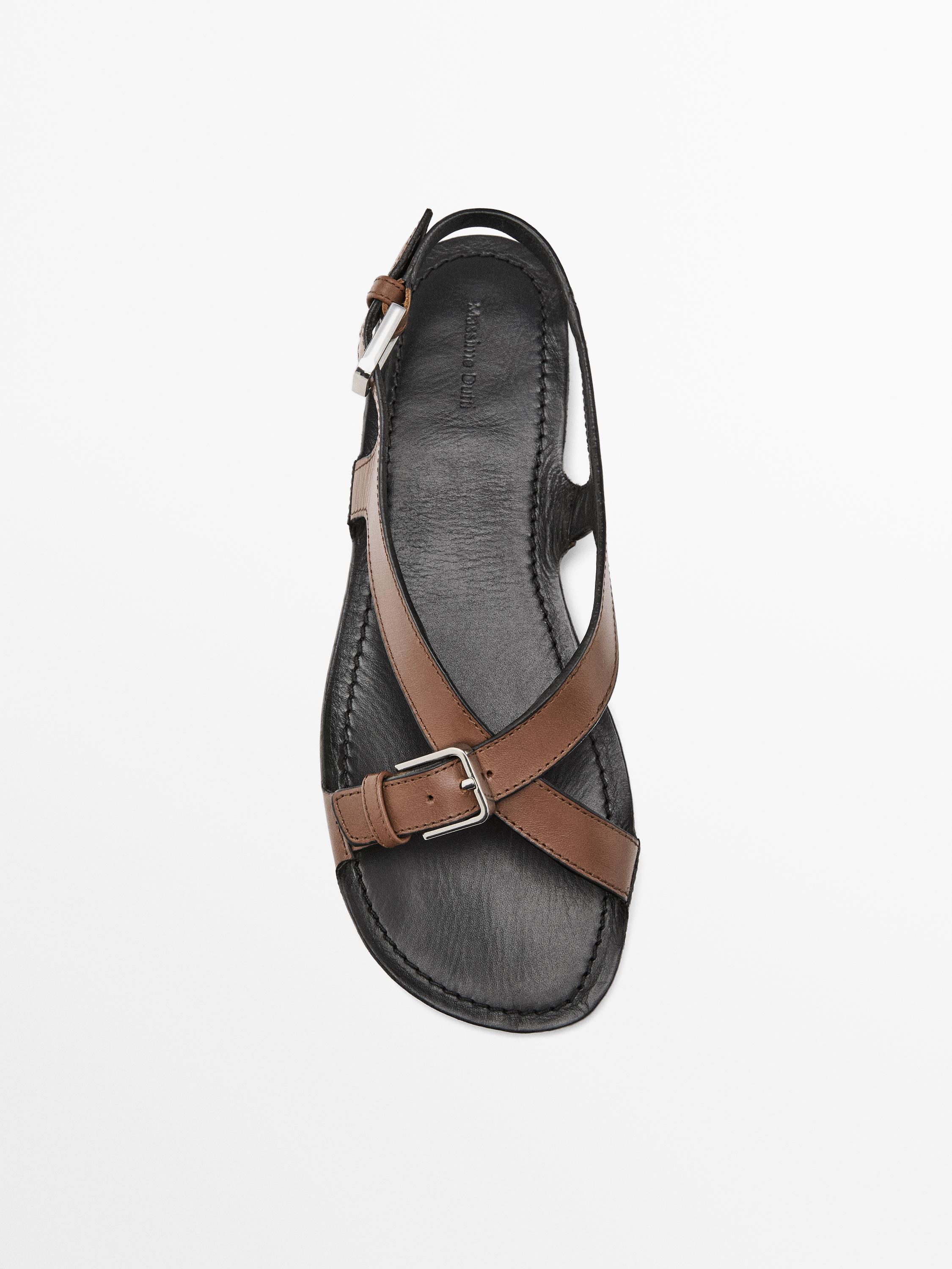 Flat leather sandals with buckles
