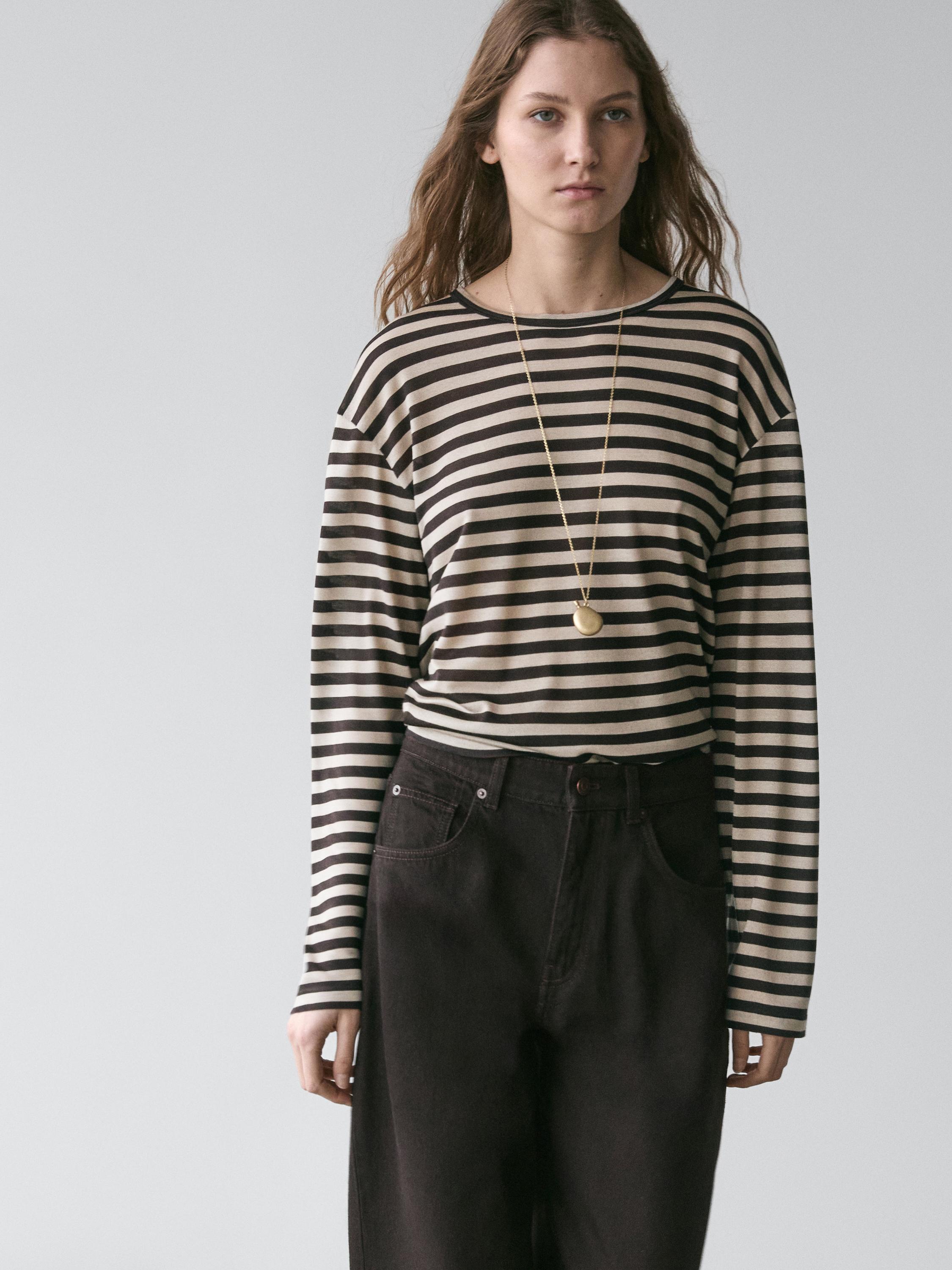 Brown long-sleeved striped T-shirt and dark pants set with side pockets.