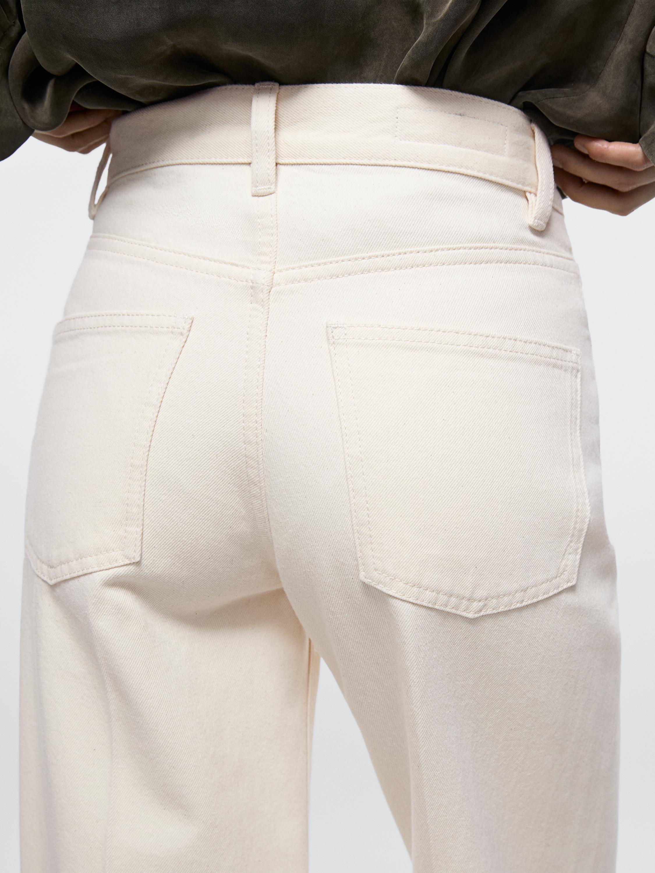 Mid-shot of raw palazzo jeans with a high waist and visible back pockets.