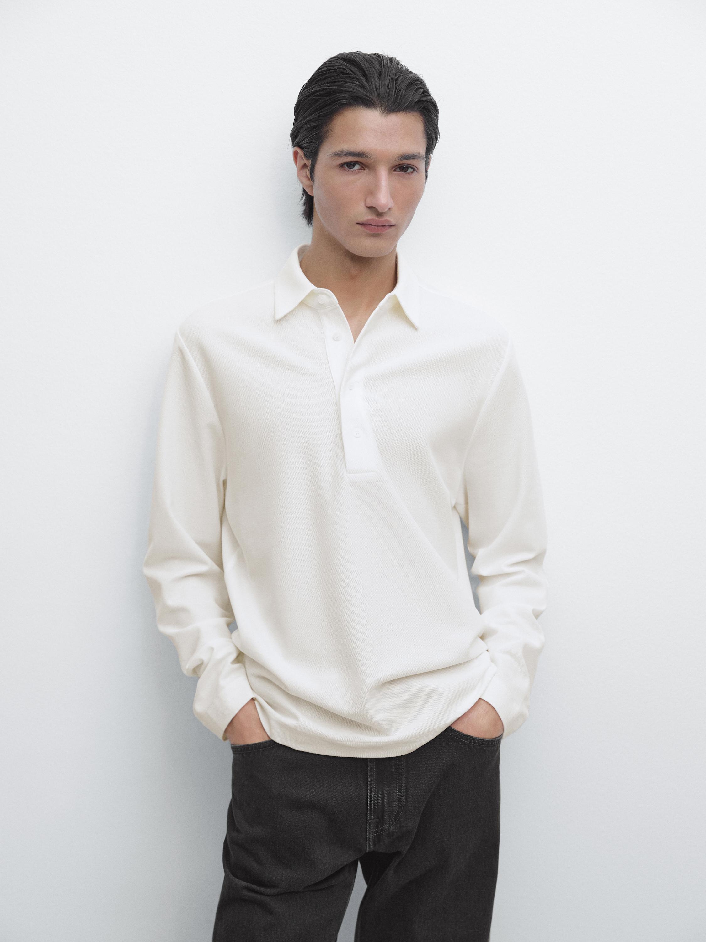 White long-sleeve polo set with placket and dark pants.