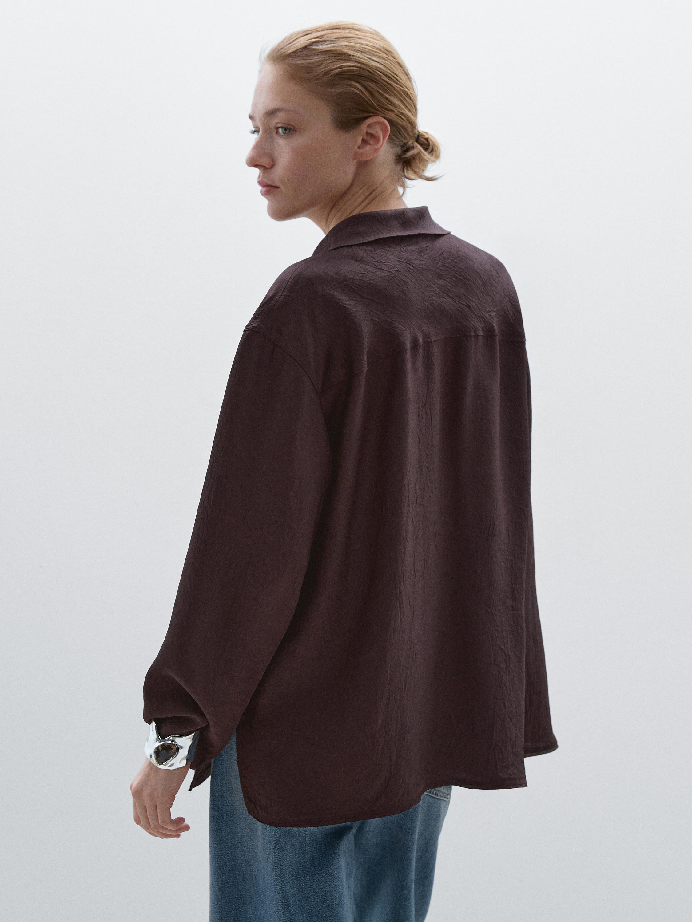 Flowing shirt featuring long sleeves with vents
