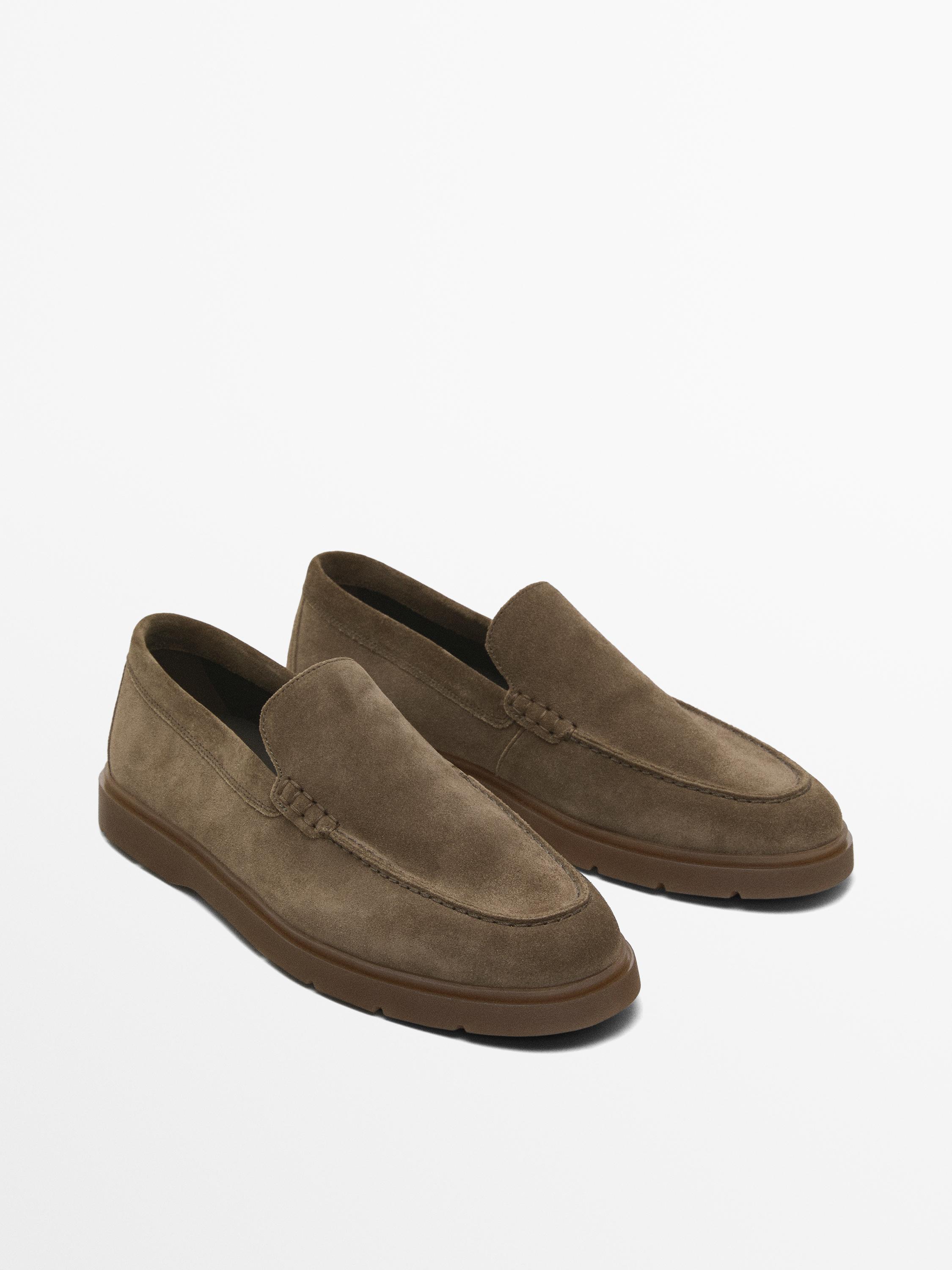 Side view of brown loafers with rubber soles.