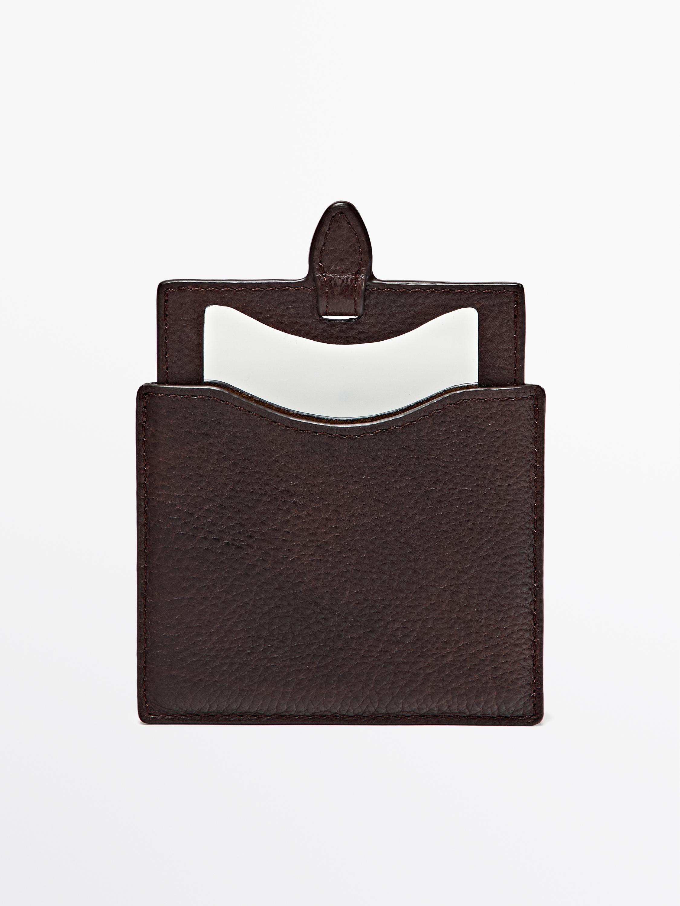 Front view of chocolate wallet with top flap and open compartment.