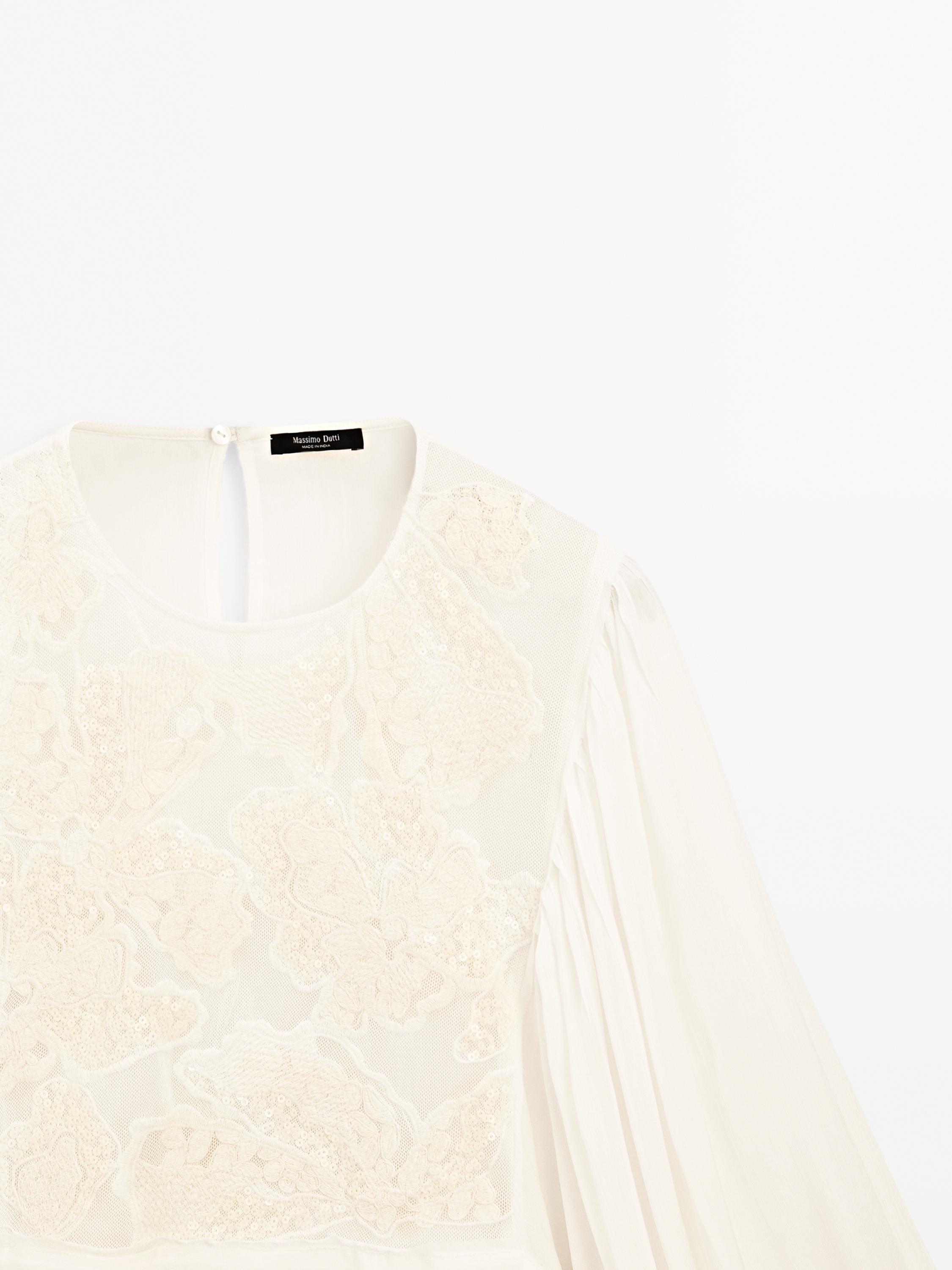 Flowing embroidered peplum blouse